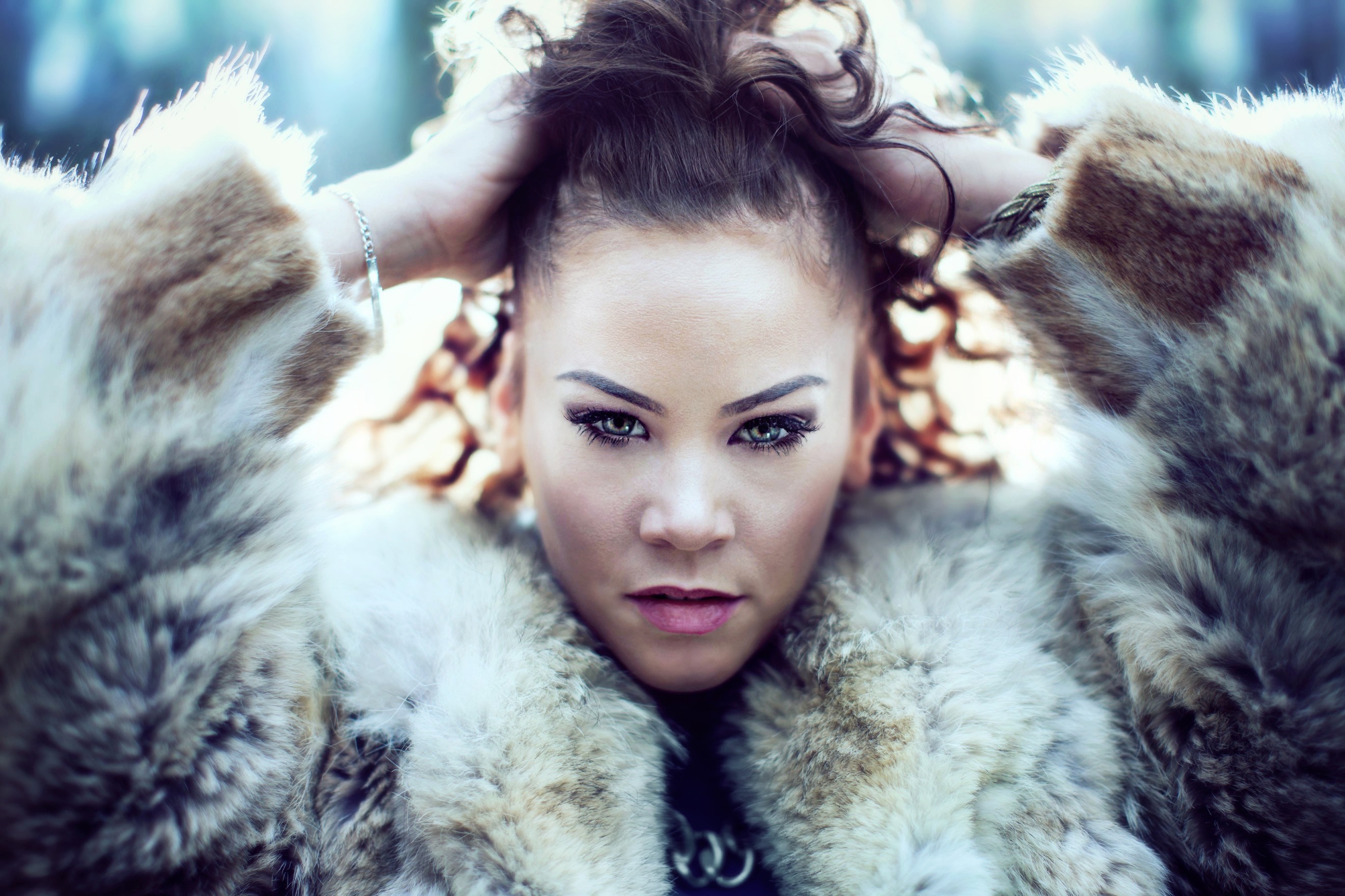 Woman in fur coat with hands in hair HD Wallpaper
