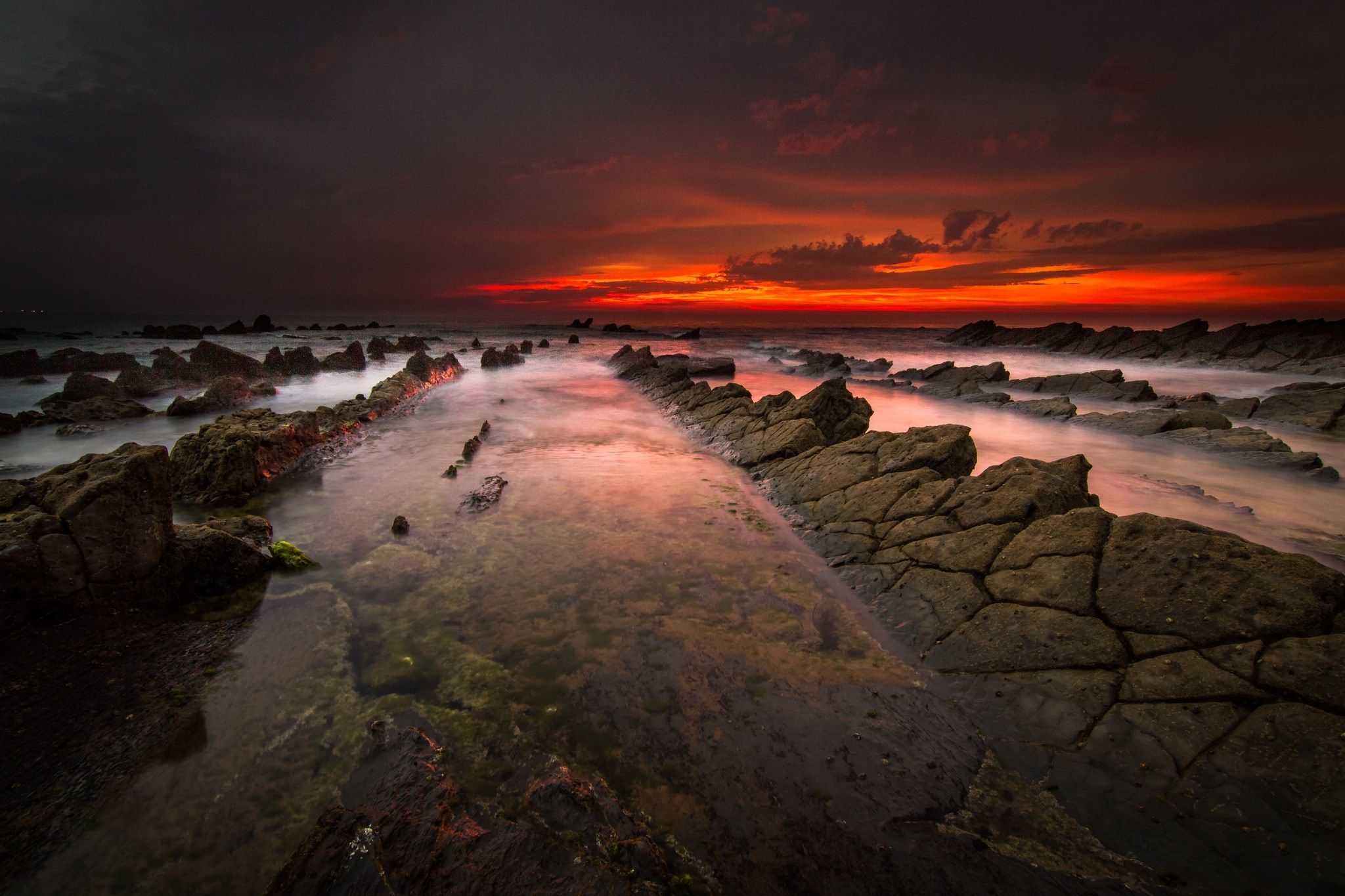 Rocky coast at sunset with dramatic sky HD Wallpaper