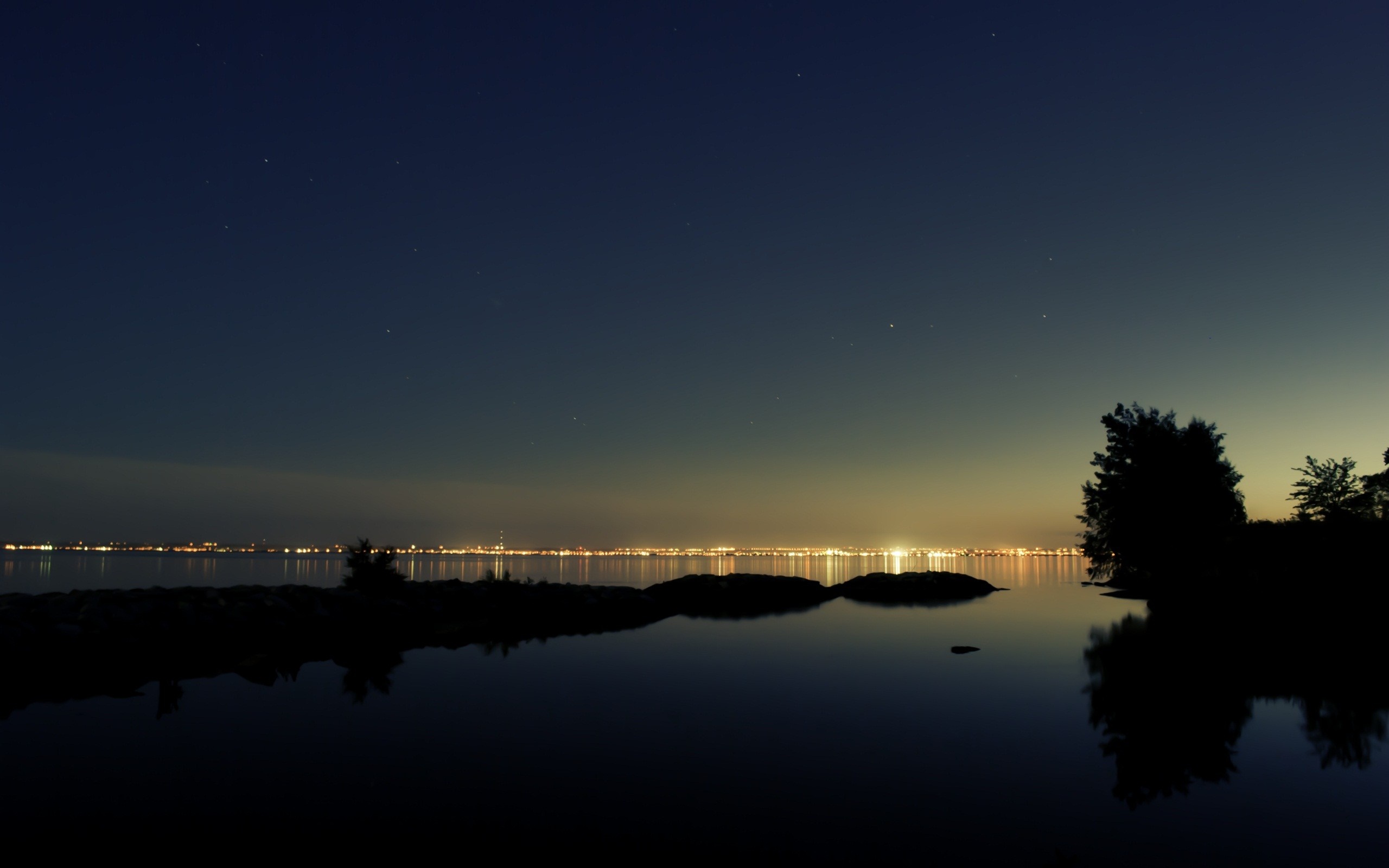 Night landscape with city lights reflecting on water HD Wallpaper