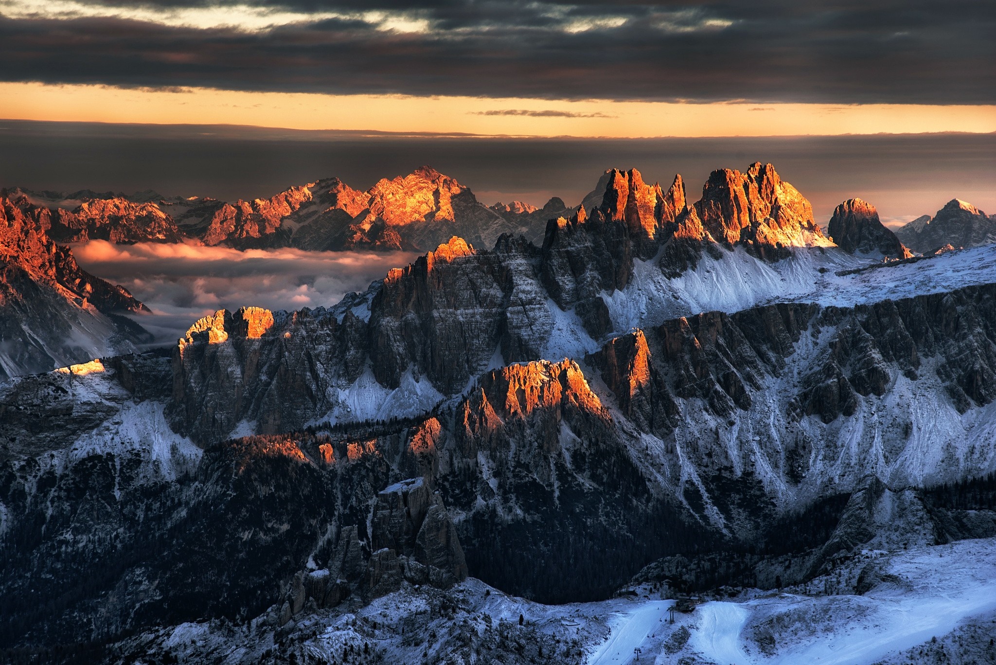 Mountain range at sunset with snow and clouds HD Wallpaper