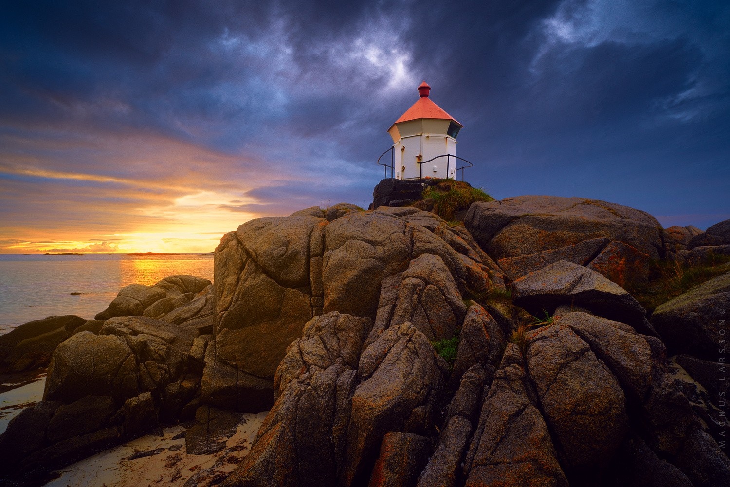 Lighthouse on rocky coast at sunset HD Wallpaper