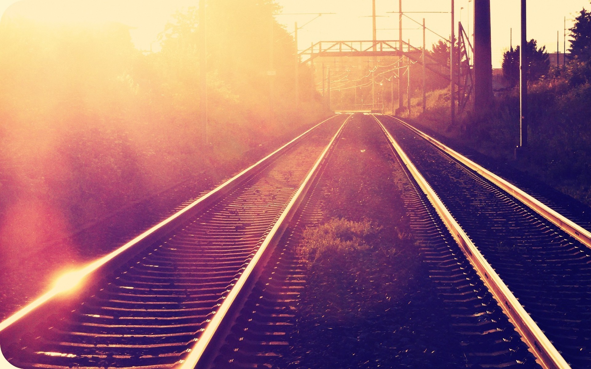 Railway tracks at sunset with sun rays HD Wallpaper