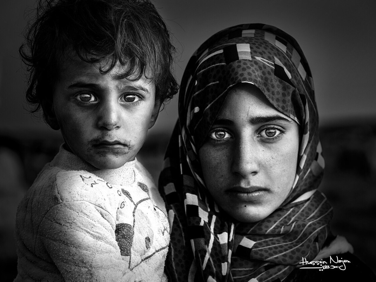 Two children, a girl and a boy, in black and white portrait HD Wallpaper