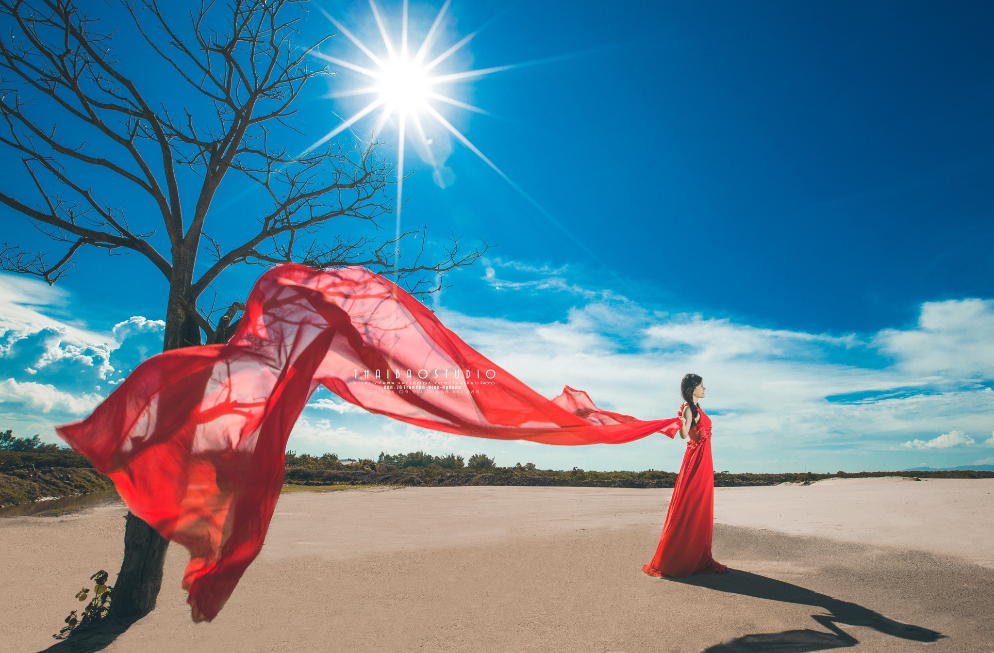 Woman in red dress with red fabric in sunlight HD Wallpaper