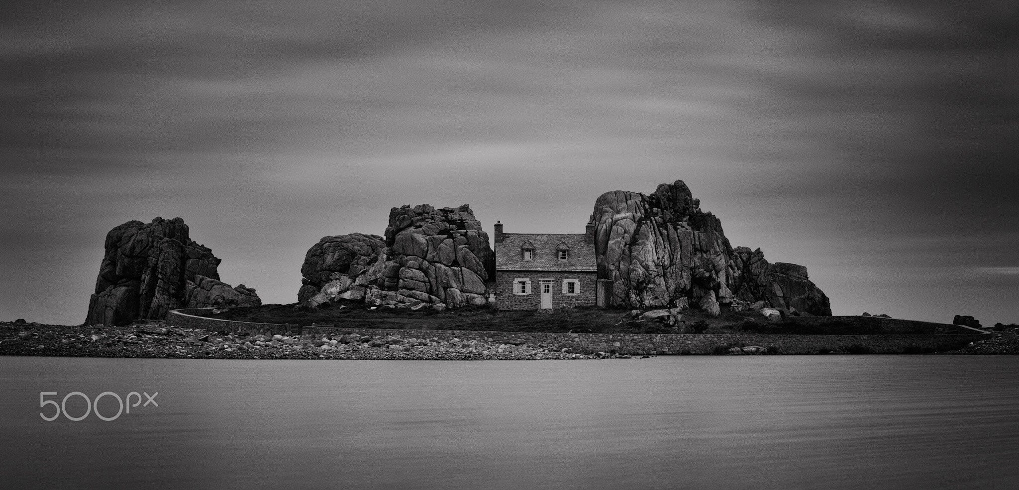 Monochrome house on rocky island with ocean HD Wallpaper