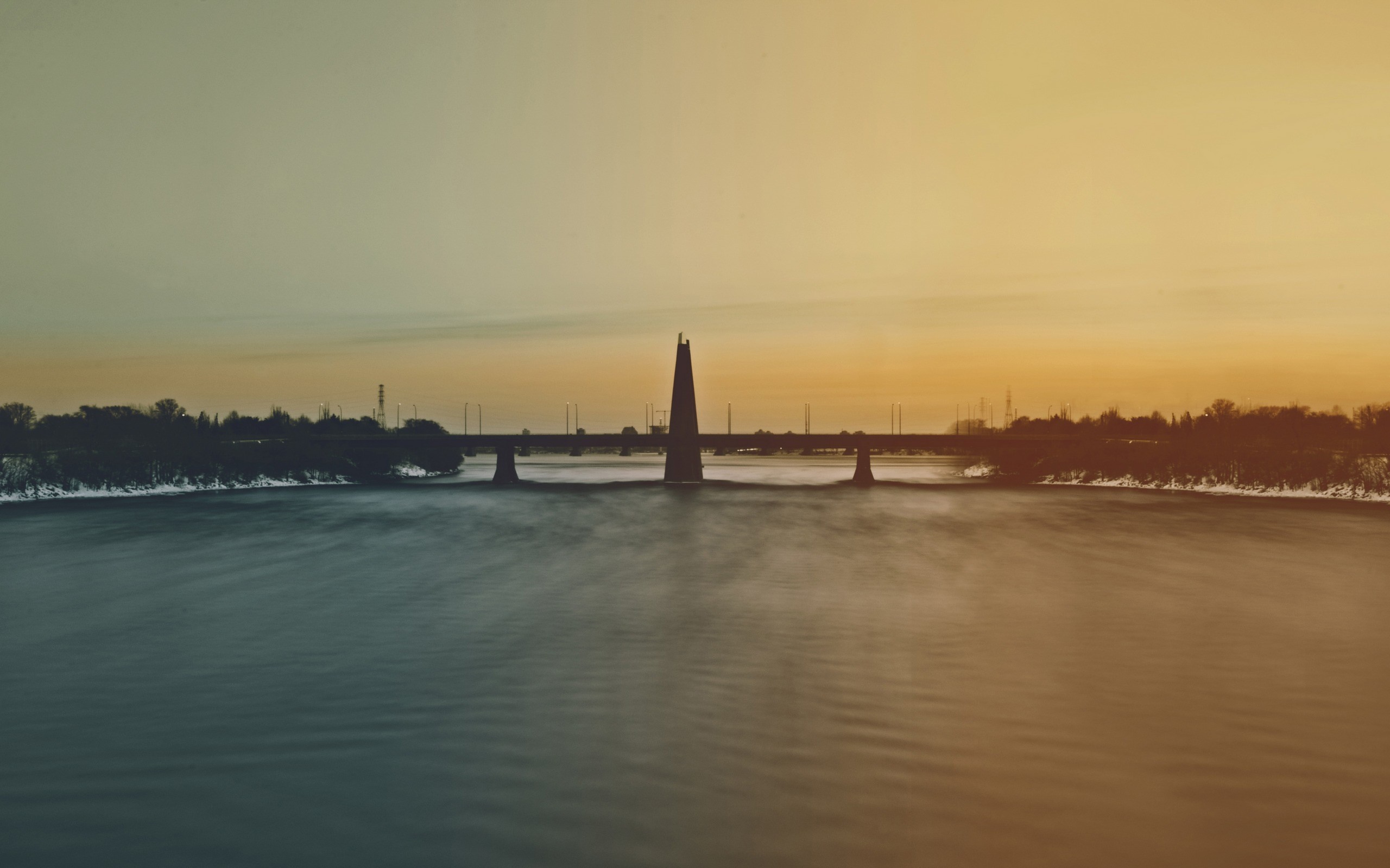 Bridge over a river at sunset with a tower HD Wallpaper