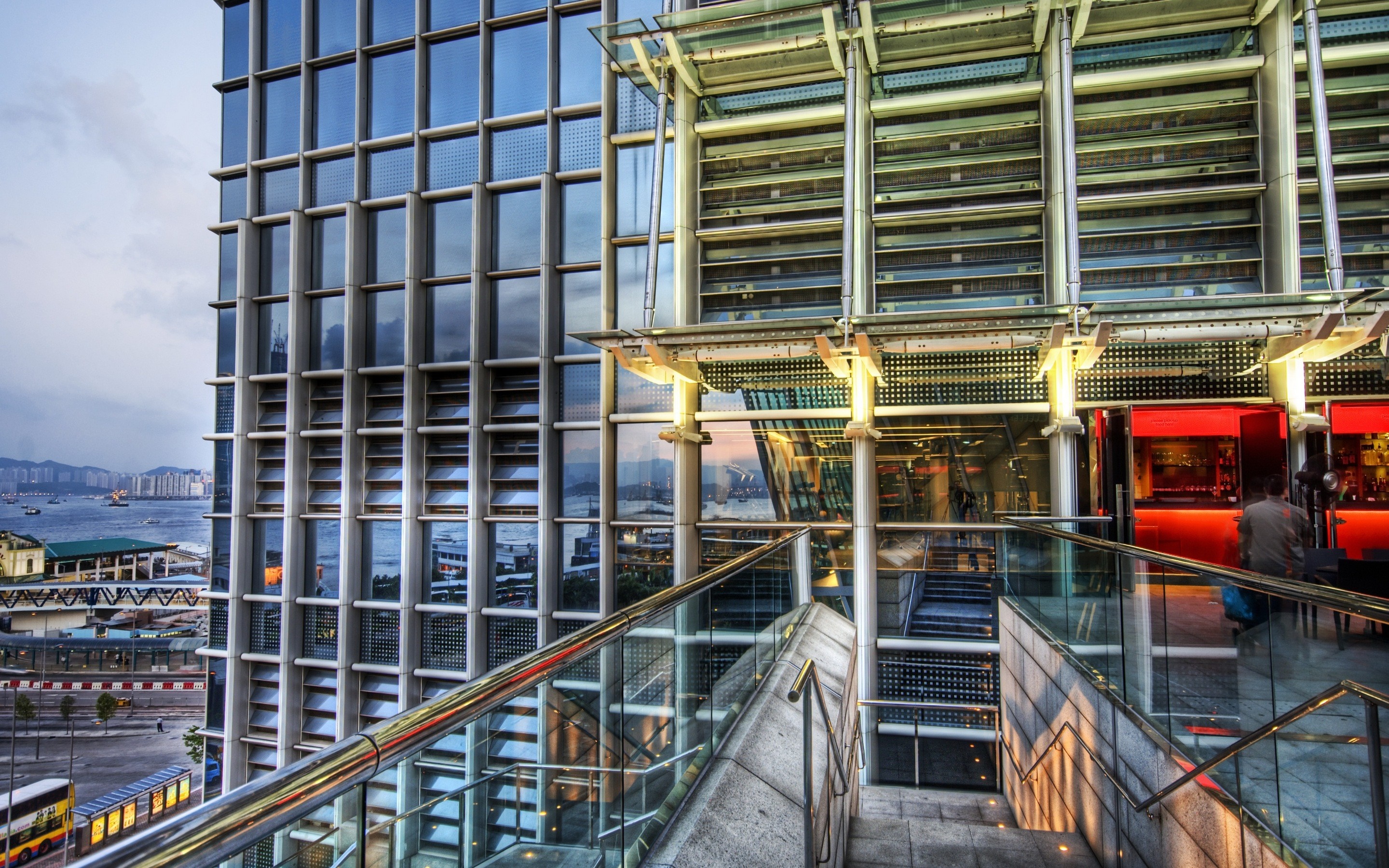 Modern building with glass facade and city view HD Wallpaper