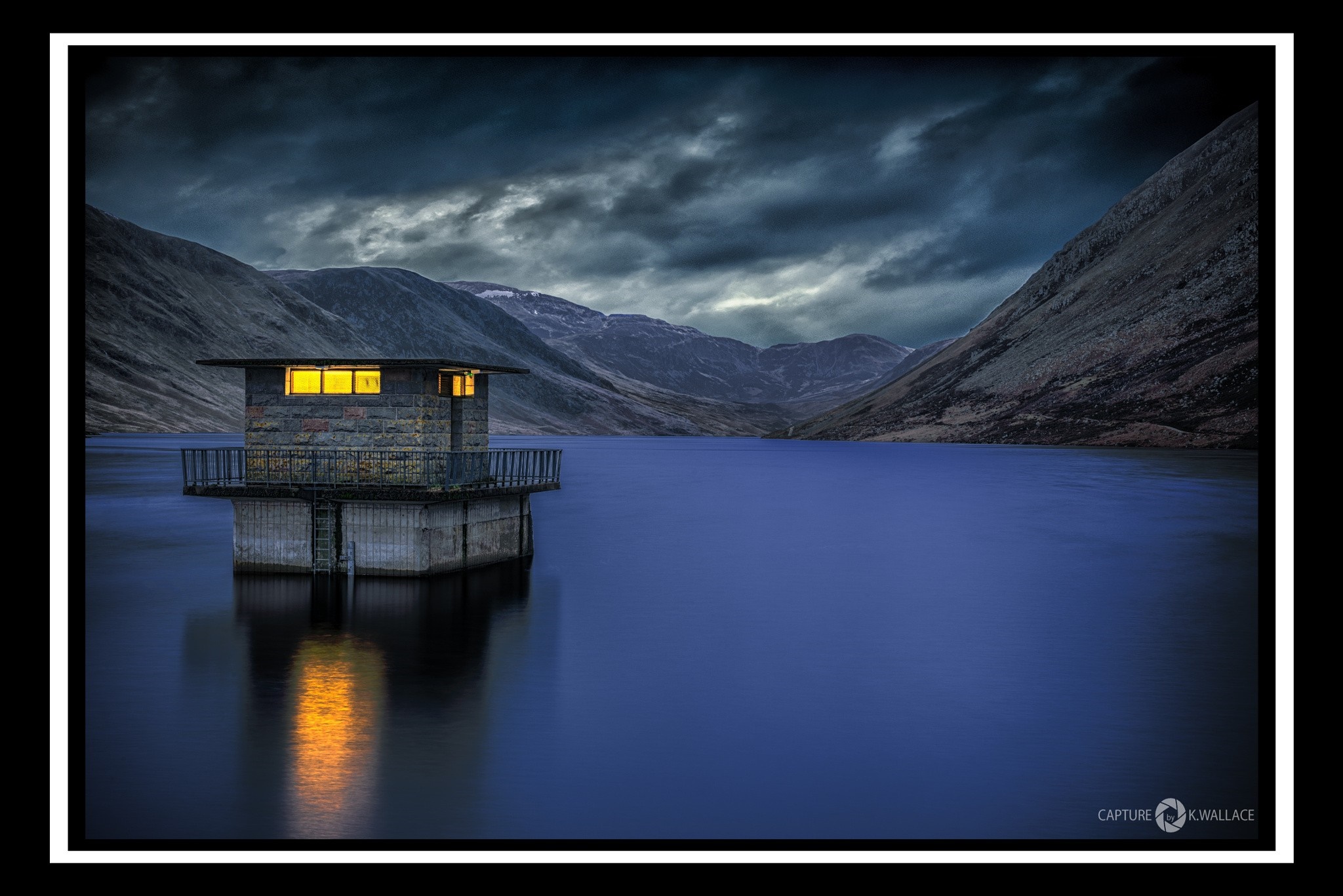 Stone structure on a lake with mountains HD Wallpaper