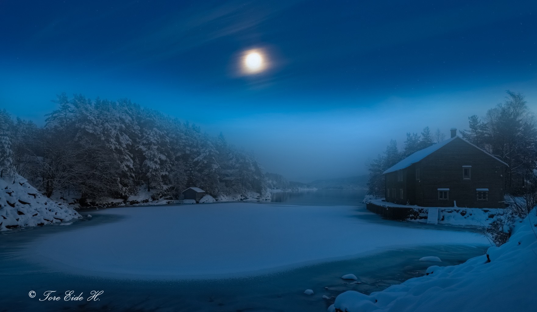 Winter night scene with moonlit lake and cabin HD Wallpaper