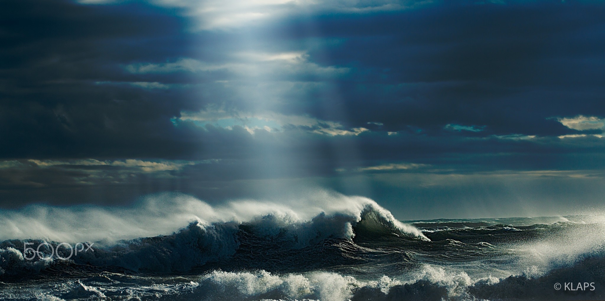 Stormy ocean waves with sunbeams breaking through clouds HD Wallpaper