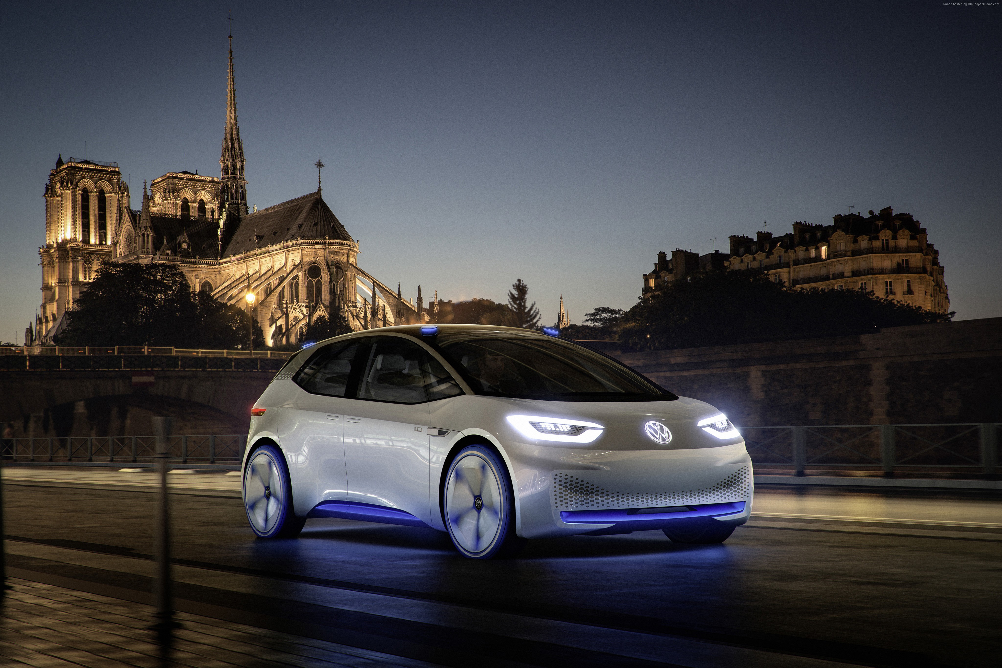 White Volkswagen I.D. electric car in Paris at night HD Wallpaper