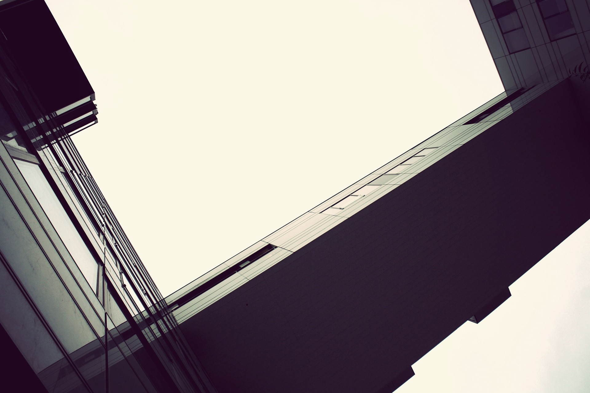Modern architecture with geometric shapes against a white sky HD Wallpaper
