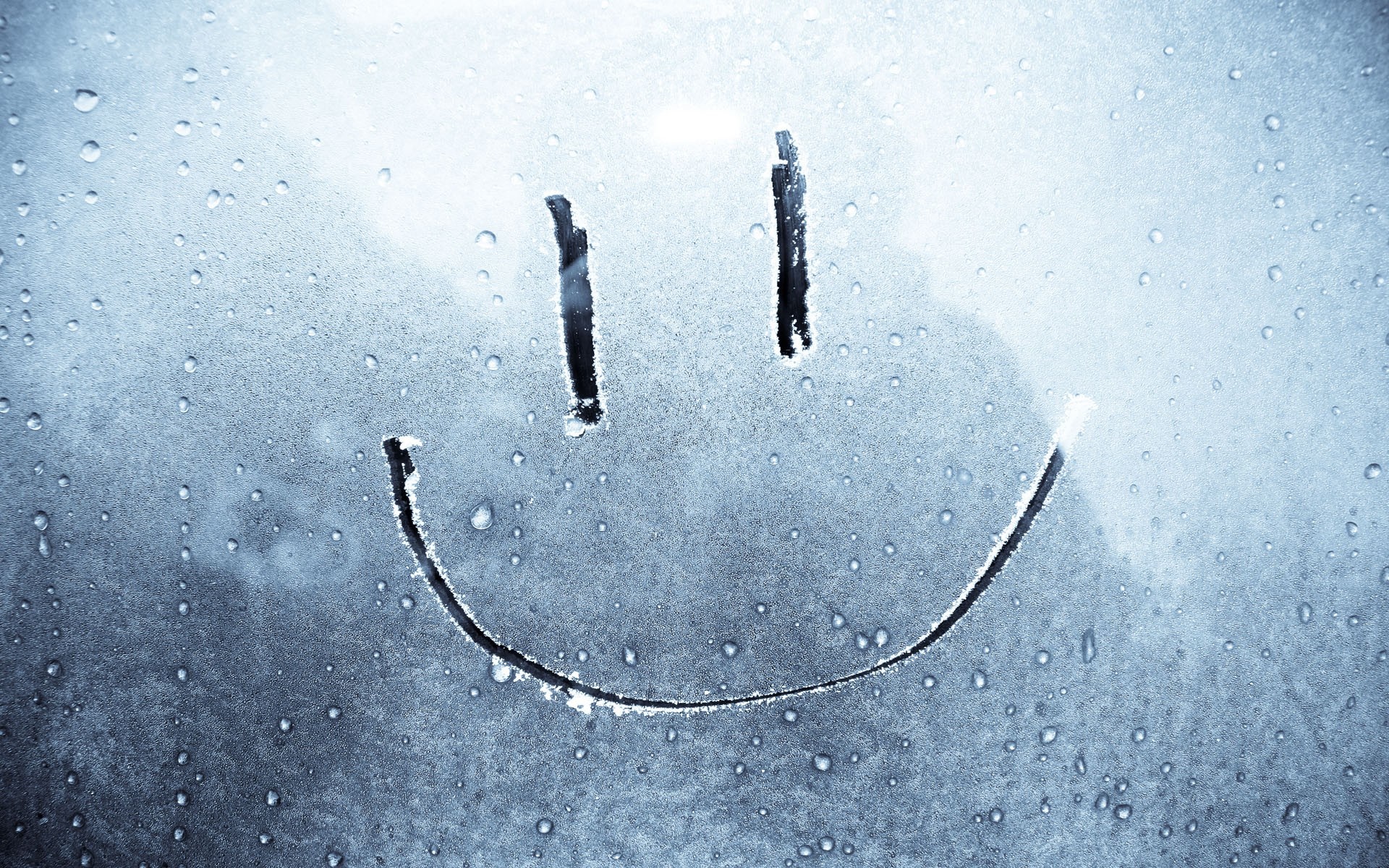 Smiley face drawn on a foggy window with water droplets HD Wallpaper