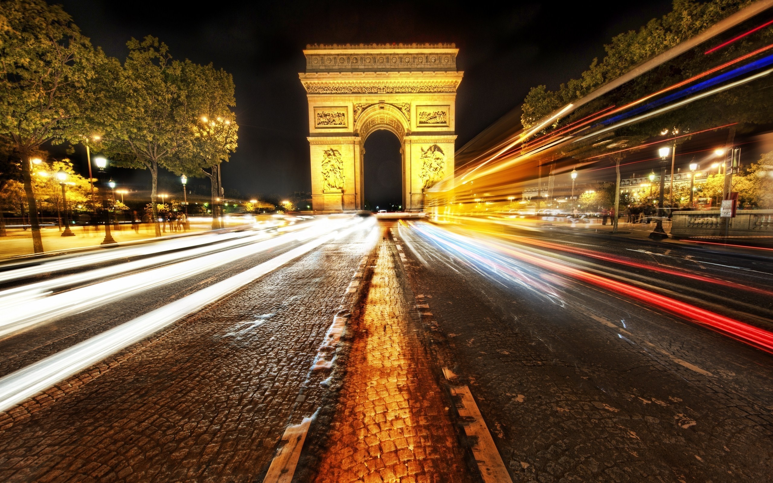 Arc de Triomphe at night with light trails HD Wallpaper