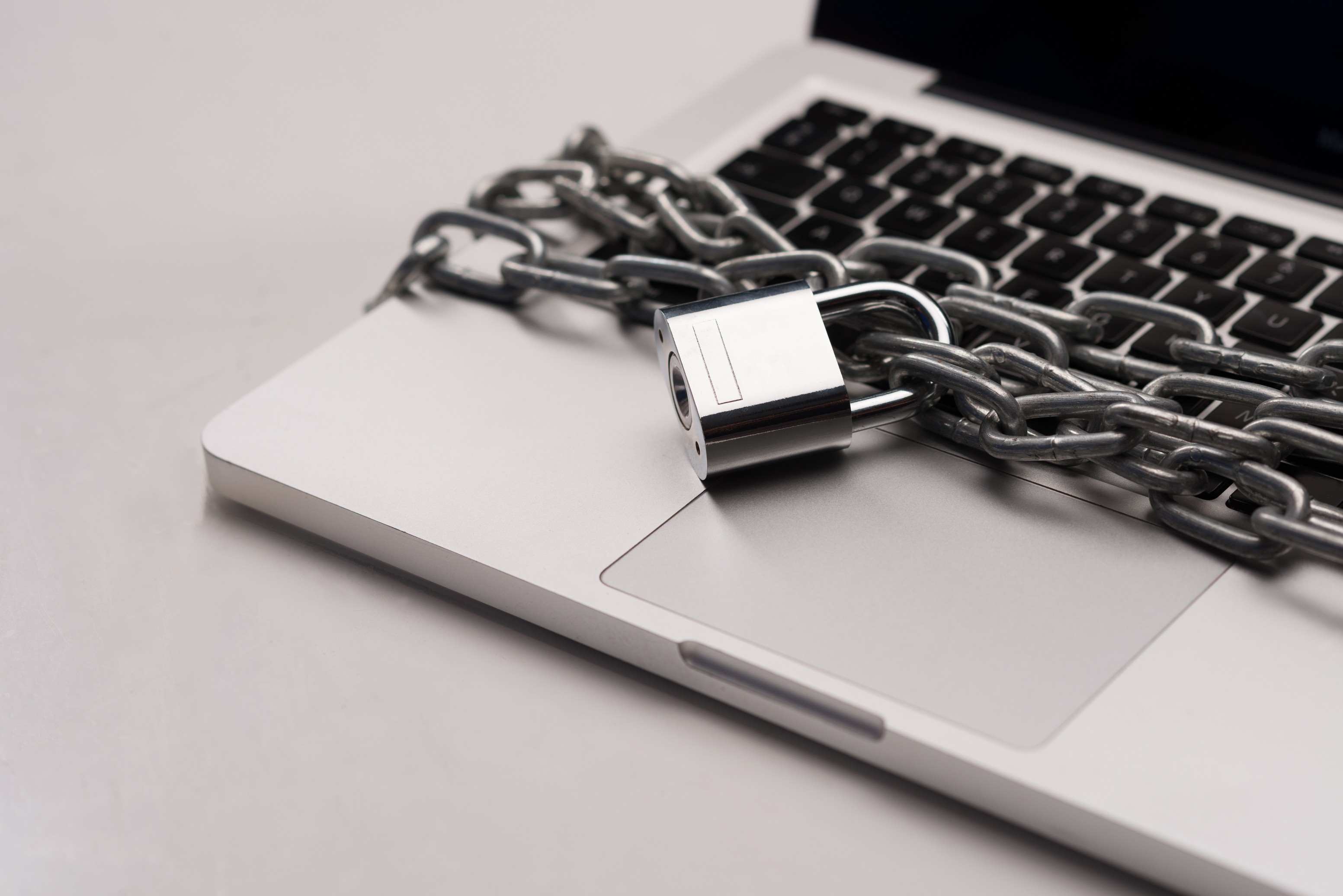 Laptop secured with a chain and padlock HD Wallpaper