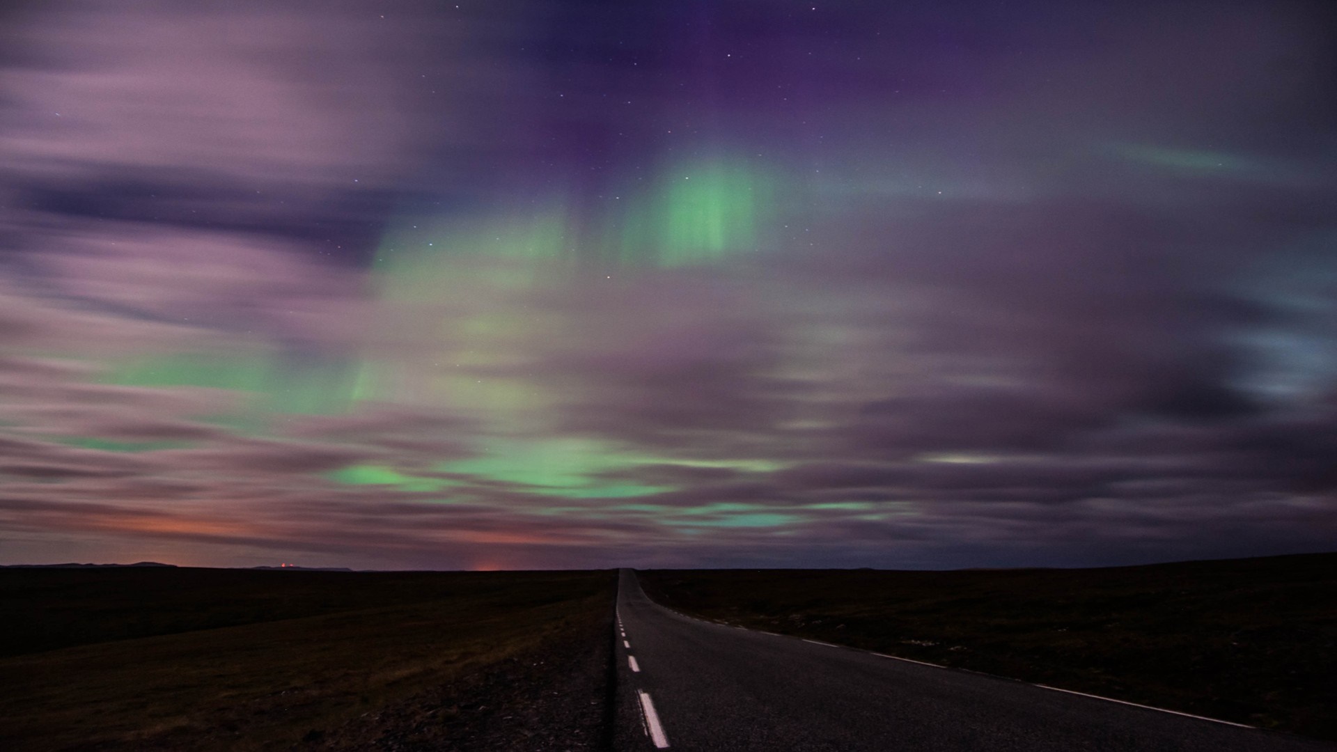 Aurora Borealis over a road at night HD Wallpaper