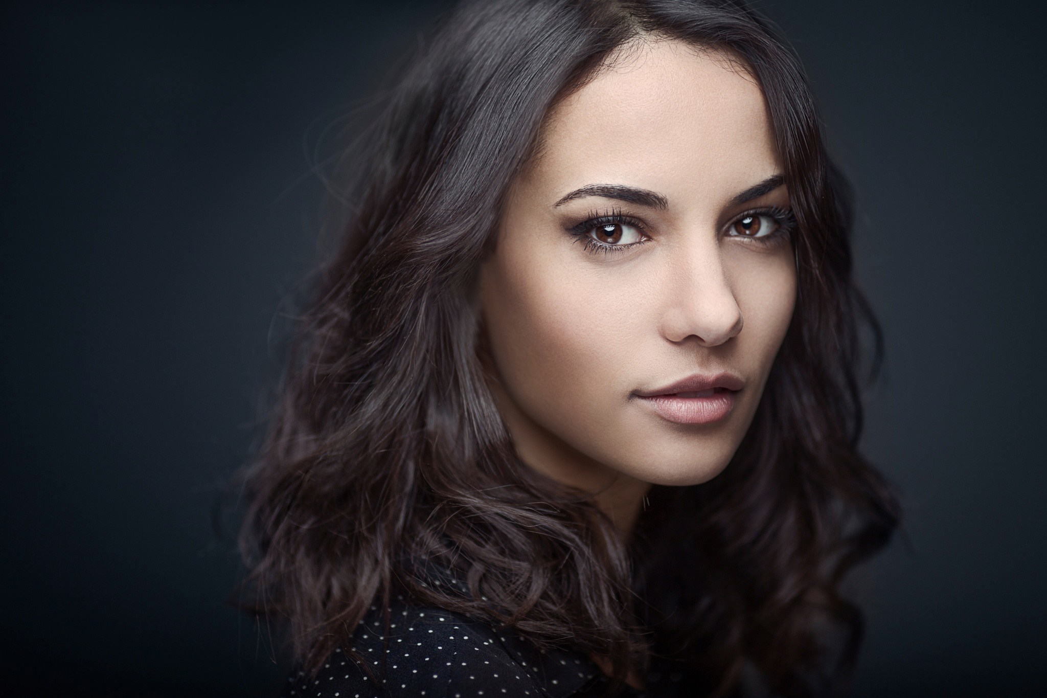 Portrait of a woman with dark wavy hair HD Wallpaper