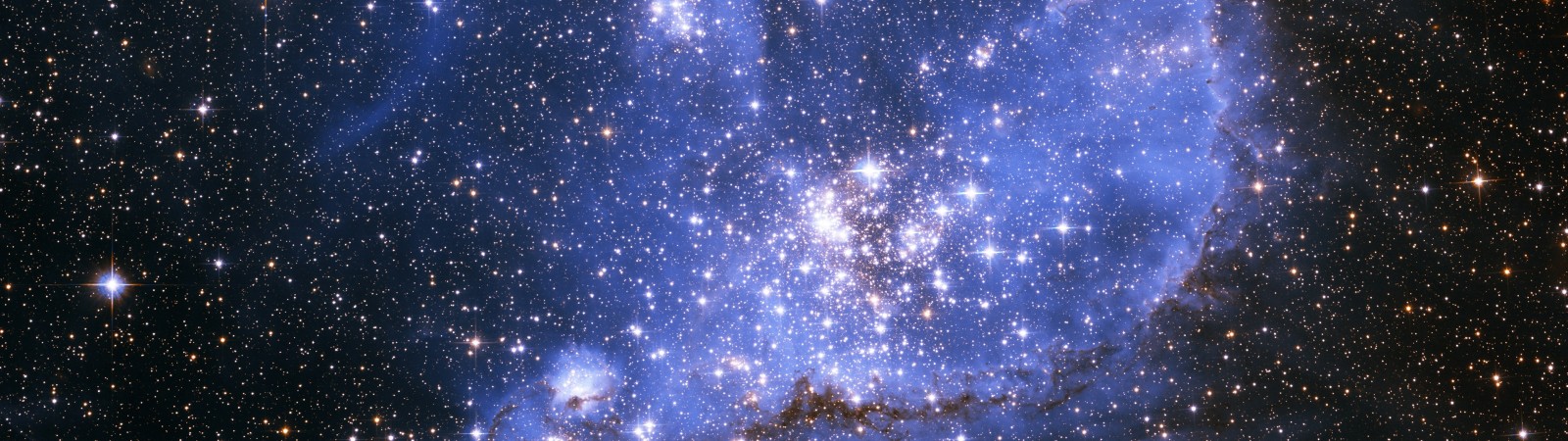 A colorful nebula filled with stars in outer space HD Wallpaper