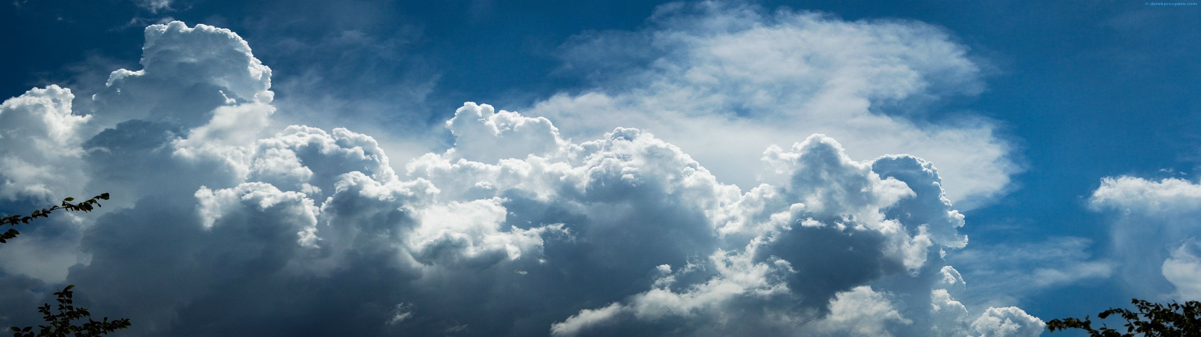 Cumulus clouds in a blue sky with sunlight HD Wallpaper