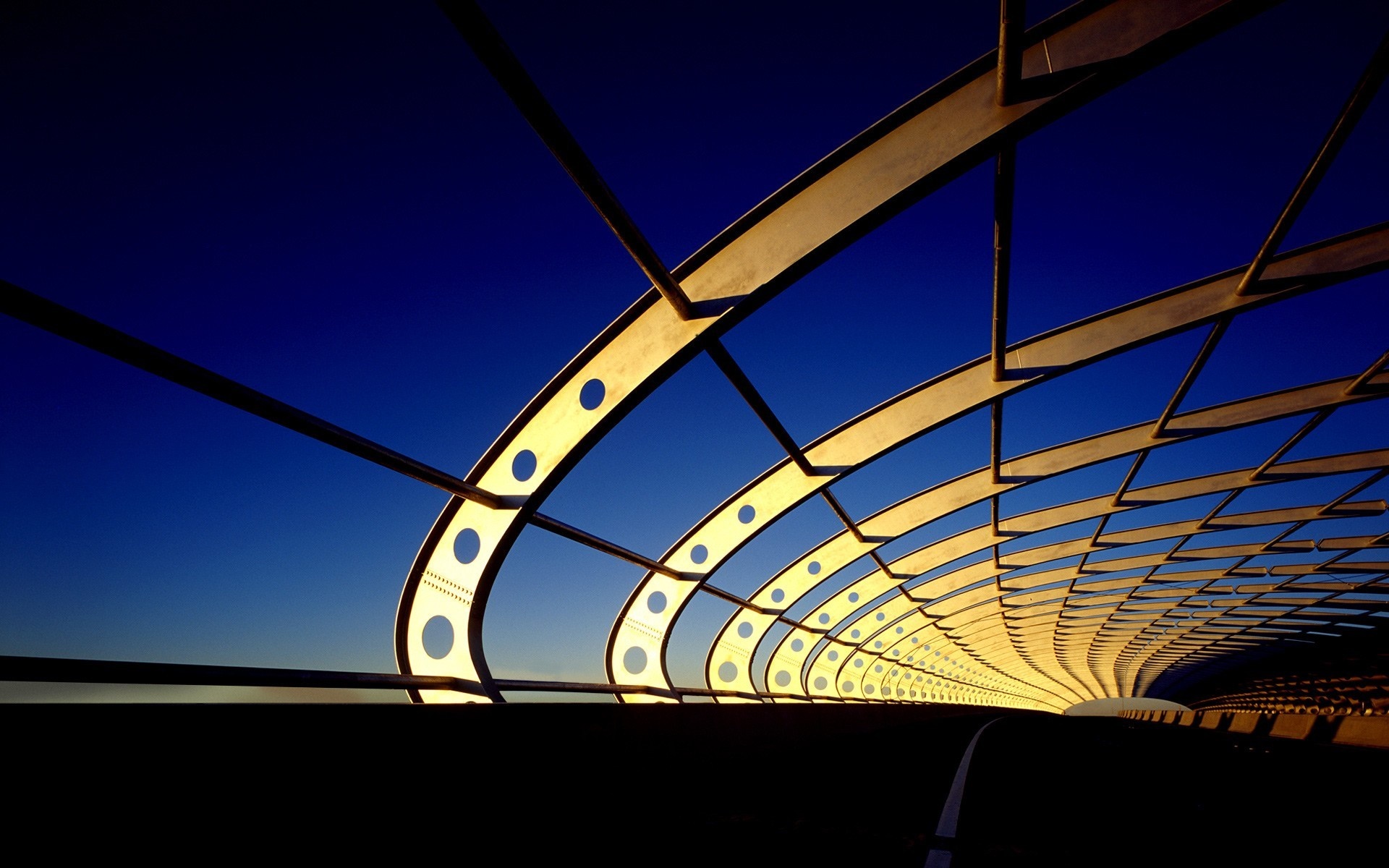 Modern bridge structure against a clear blue sky HD Wallpaper