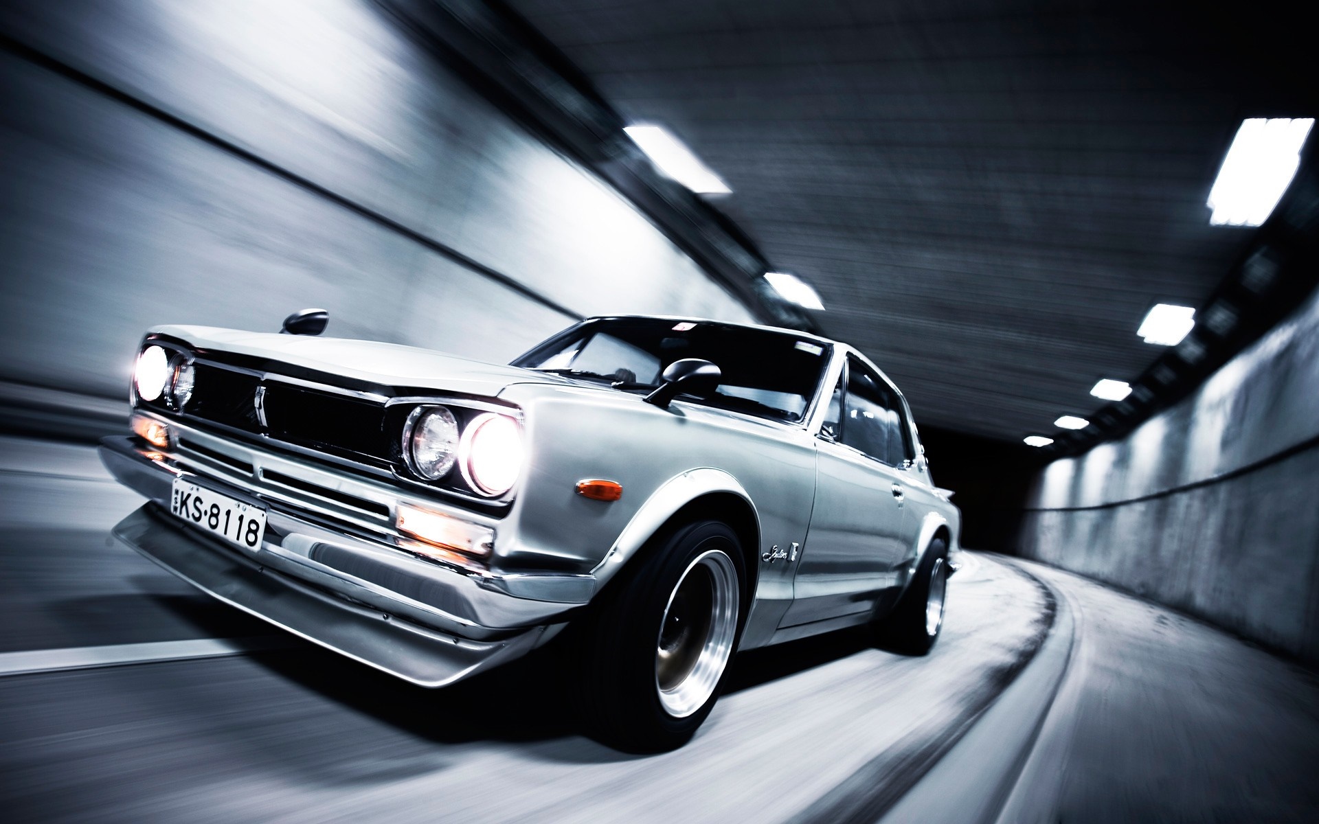 Silver classic Nissan Skyline GT-R driving through a tunnel HD Wallpaper