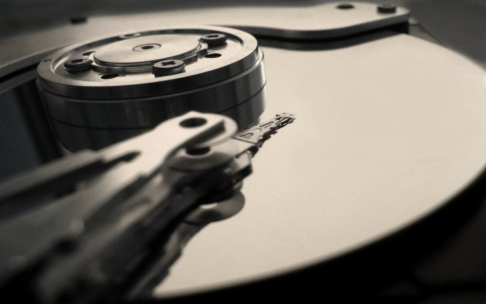 Close up of a hard drive platter and read/write head HD Wallpaper