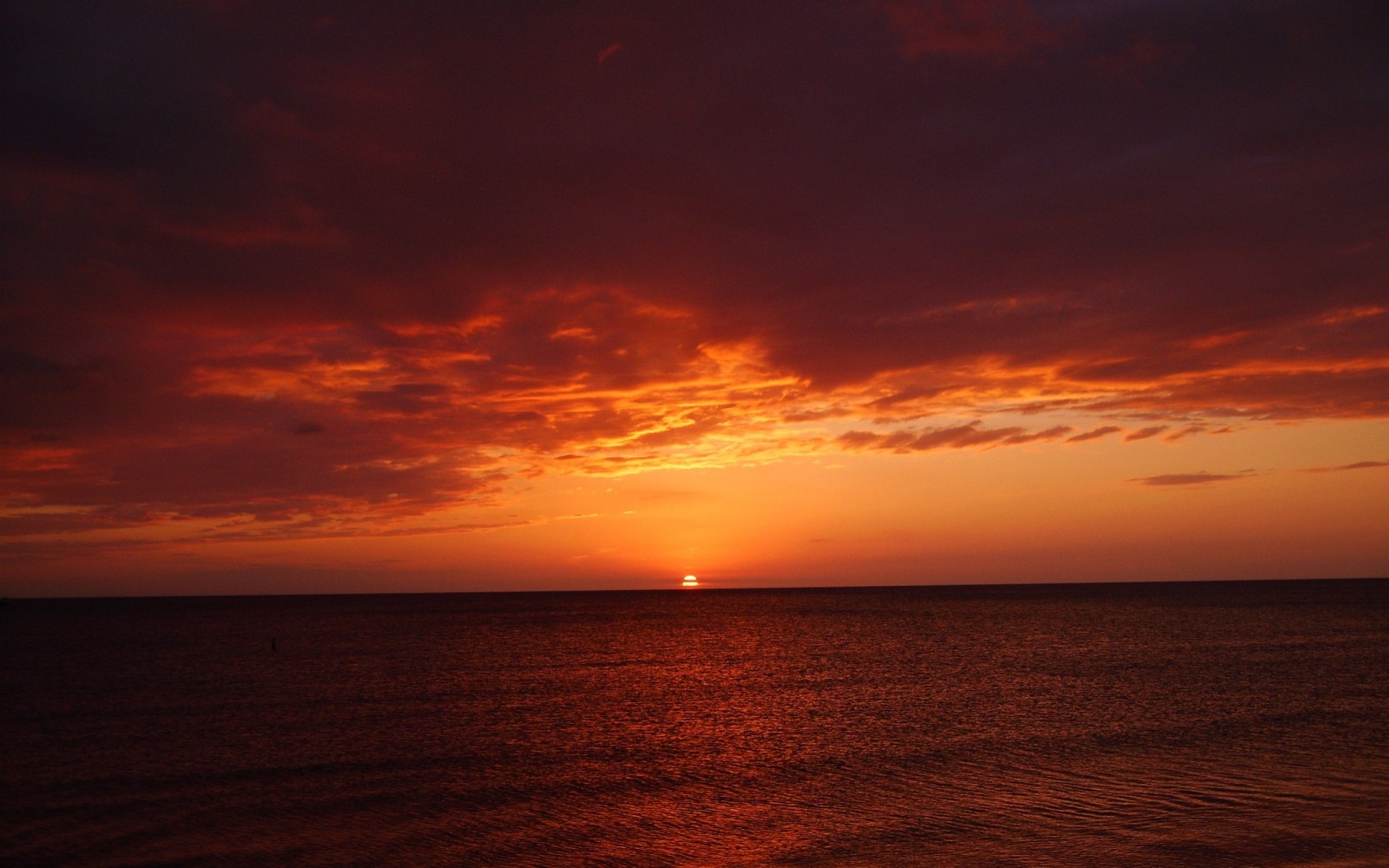 Sunset over the ocean with dramatic clouds HD Wallpaper