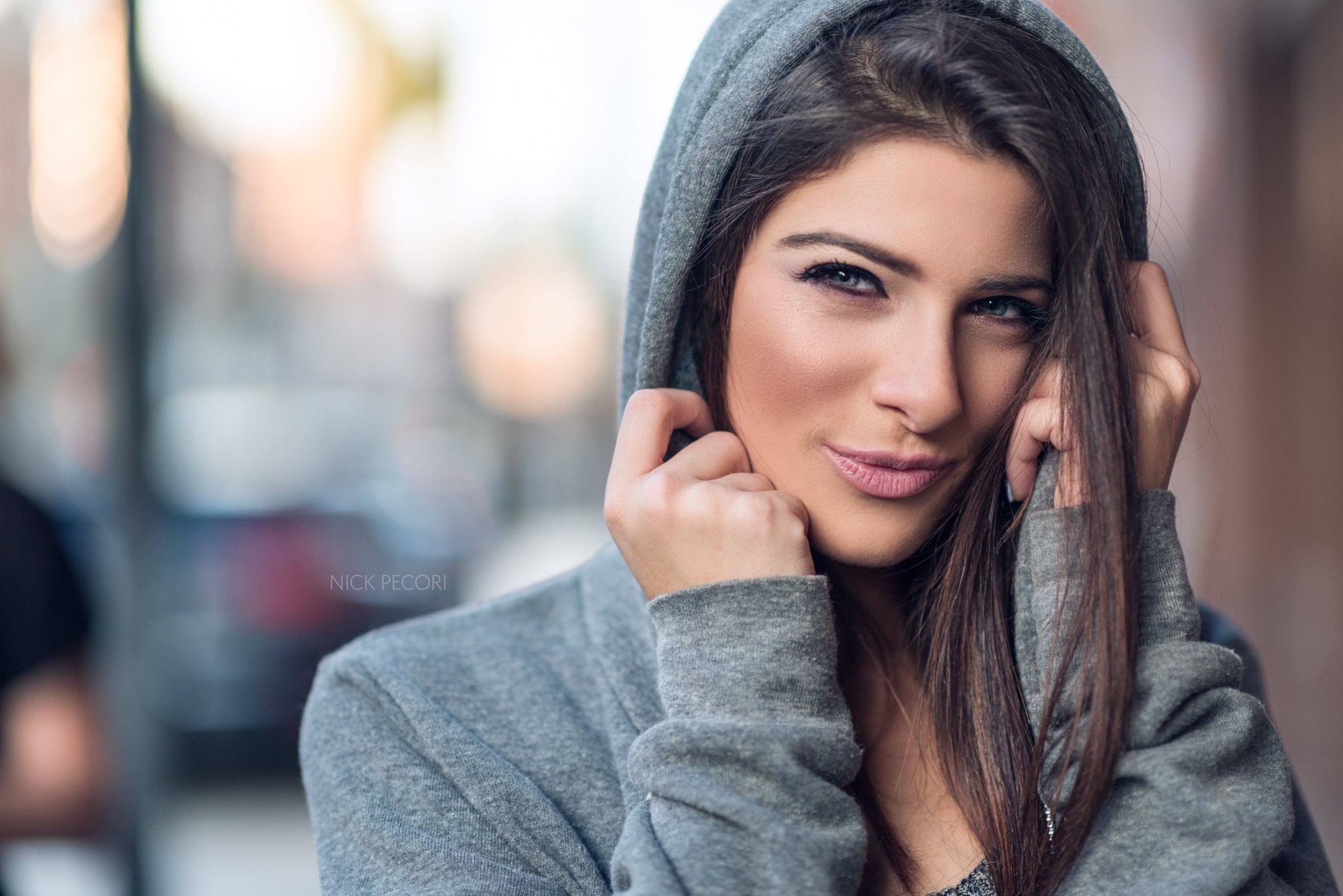 Woman in a grey hoodie with dark hair HD Wallpaper