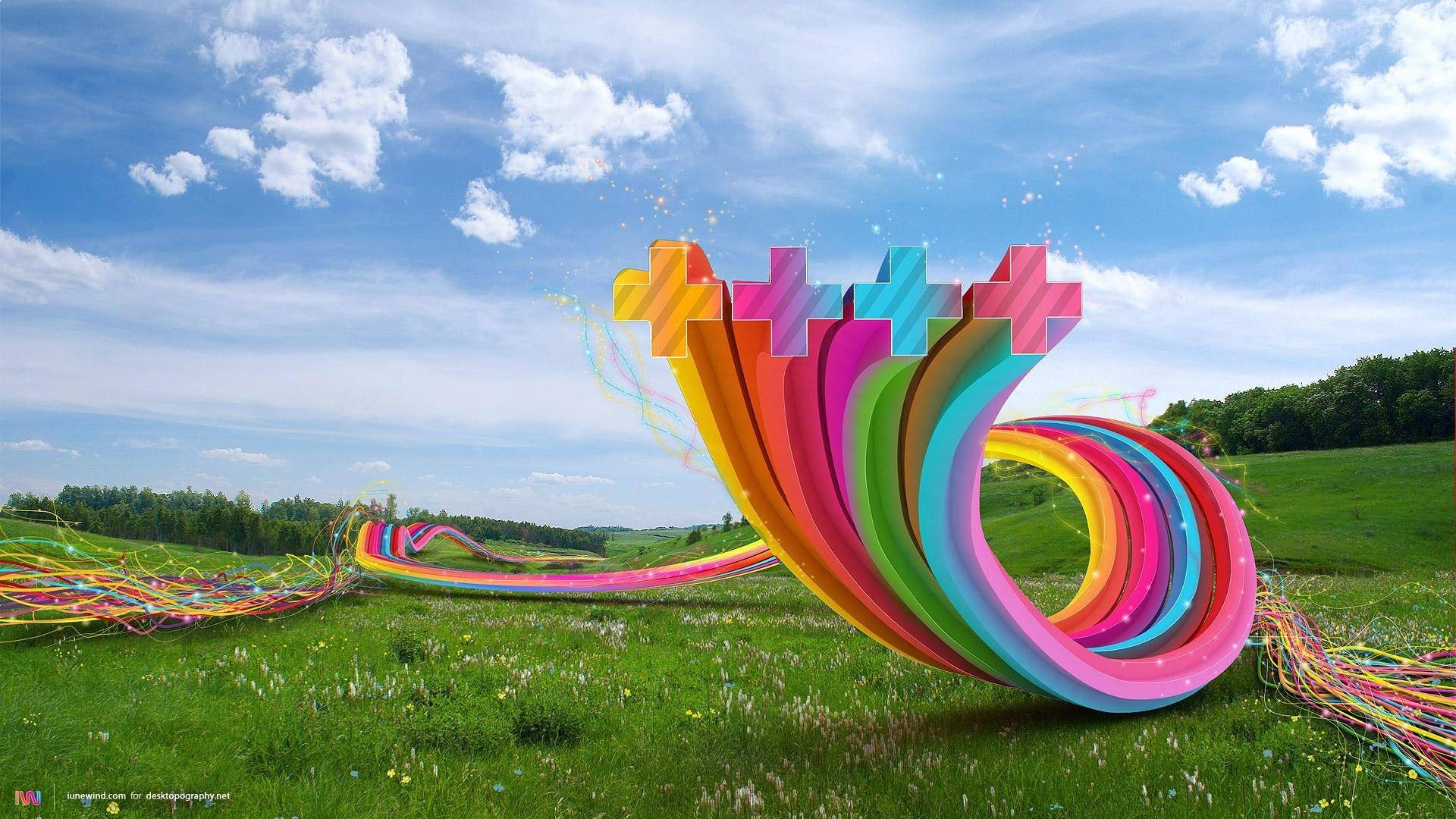 Colorful abstract shapes in a grassy landscape under a blue sky HD Wallpaper