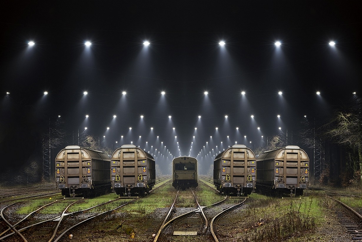 Freight trains lined up at night under stadium lights HD Wallpaper