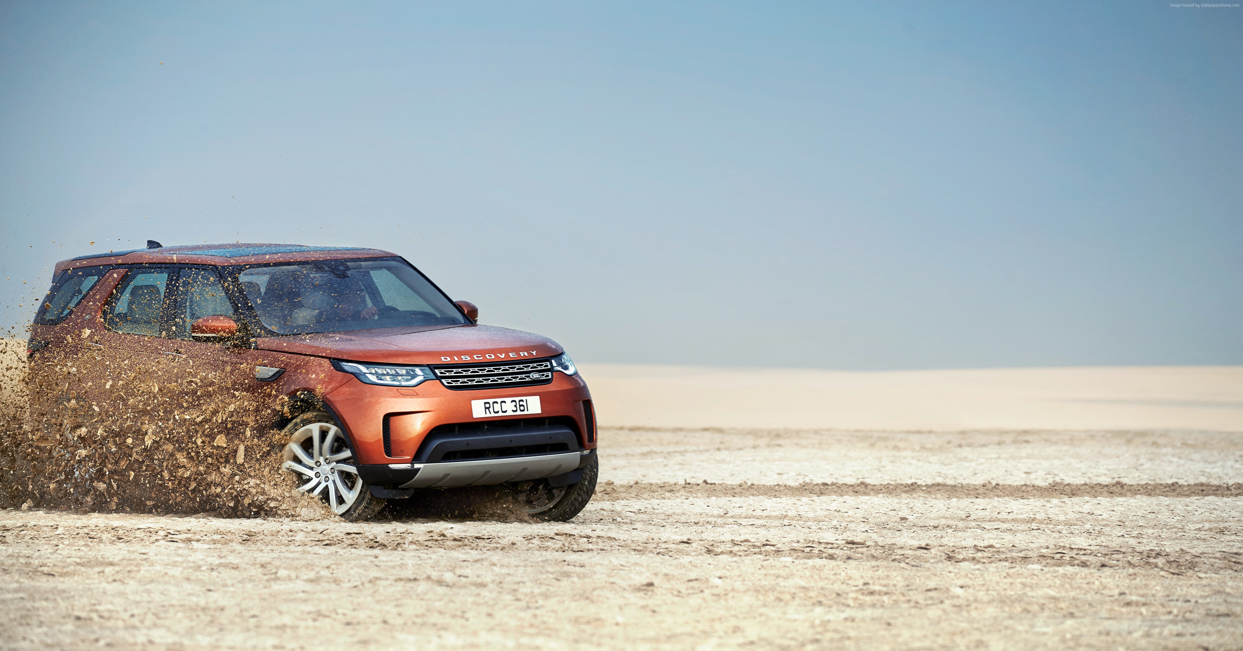 Land Rover Discovery driving through mud HD Wallpaper