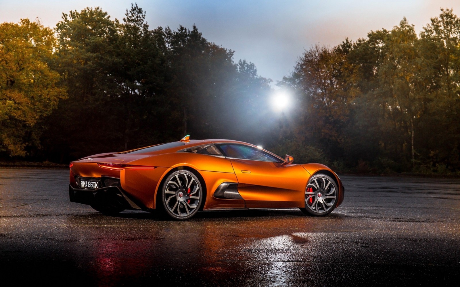 Orange Jaguar C-X75 sports car on wet asphalt HD Wallpaper