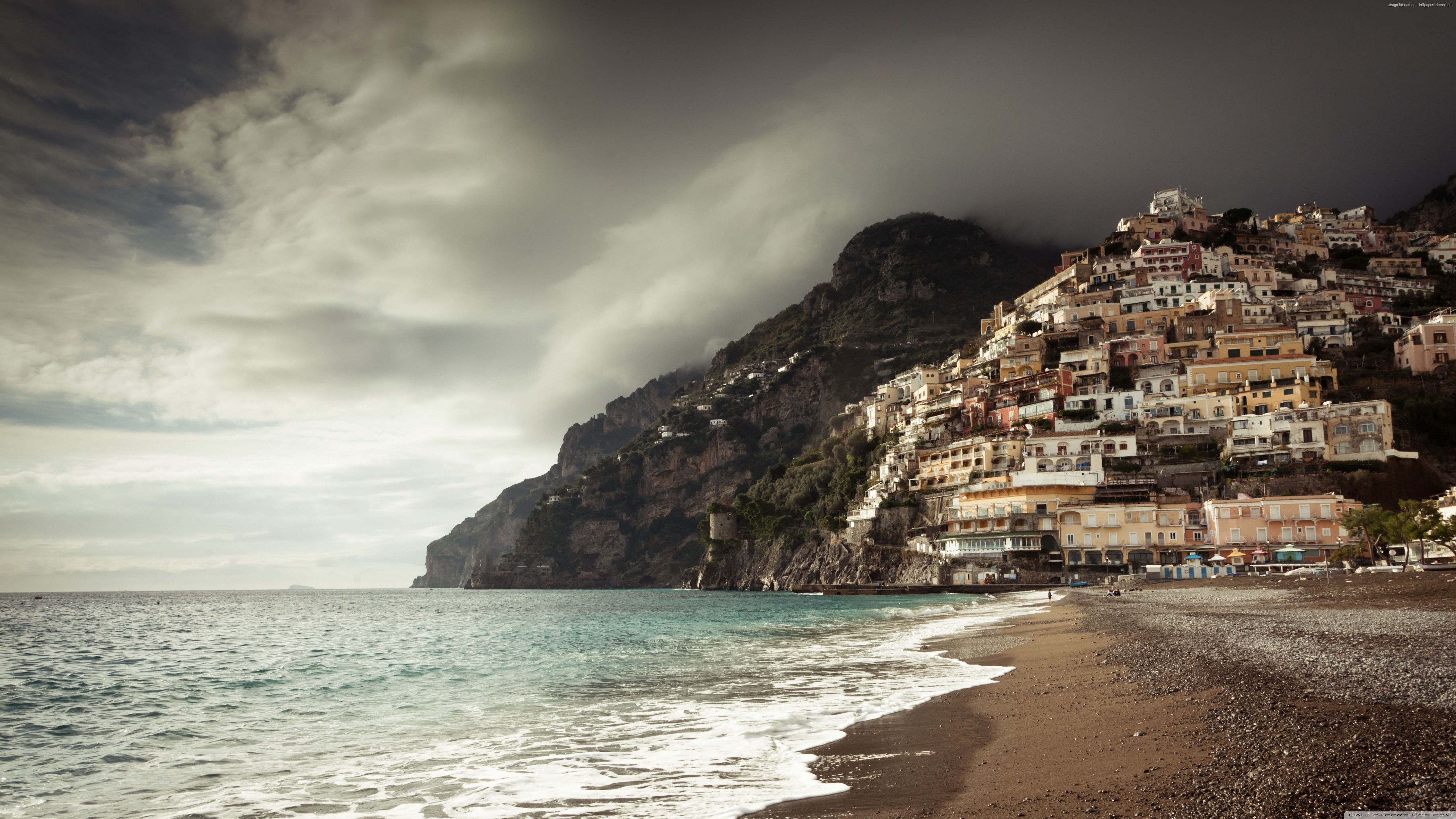 Positano coast with colorful buildings and cloudy sky HD Wallpaper