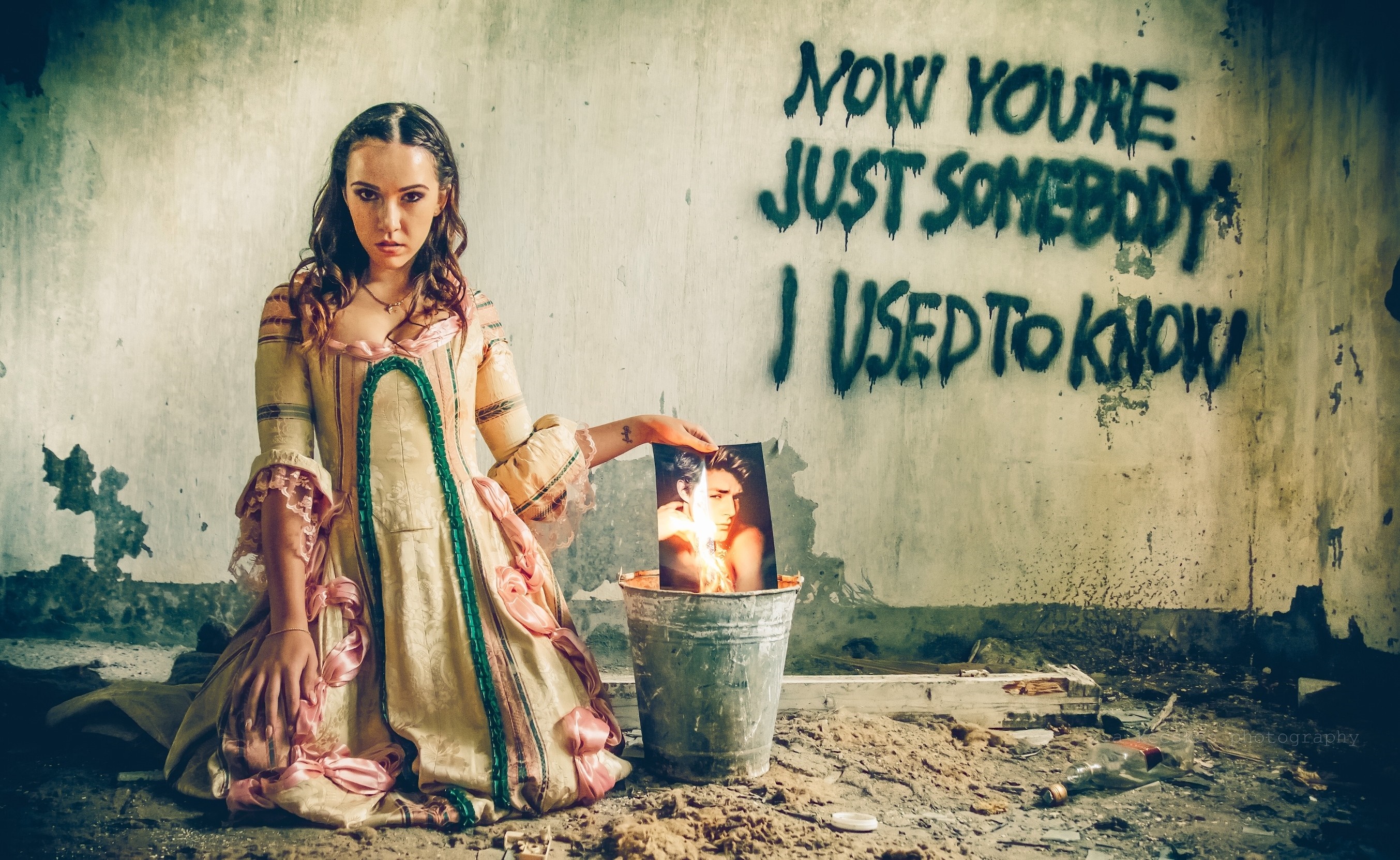 Woman in historical dress holding a burning photograph HD Wallpaper