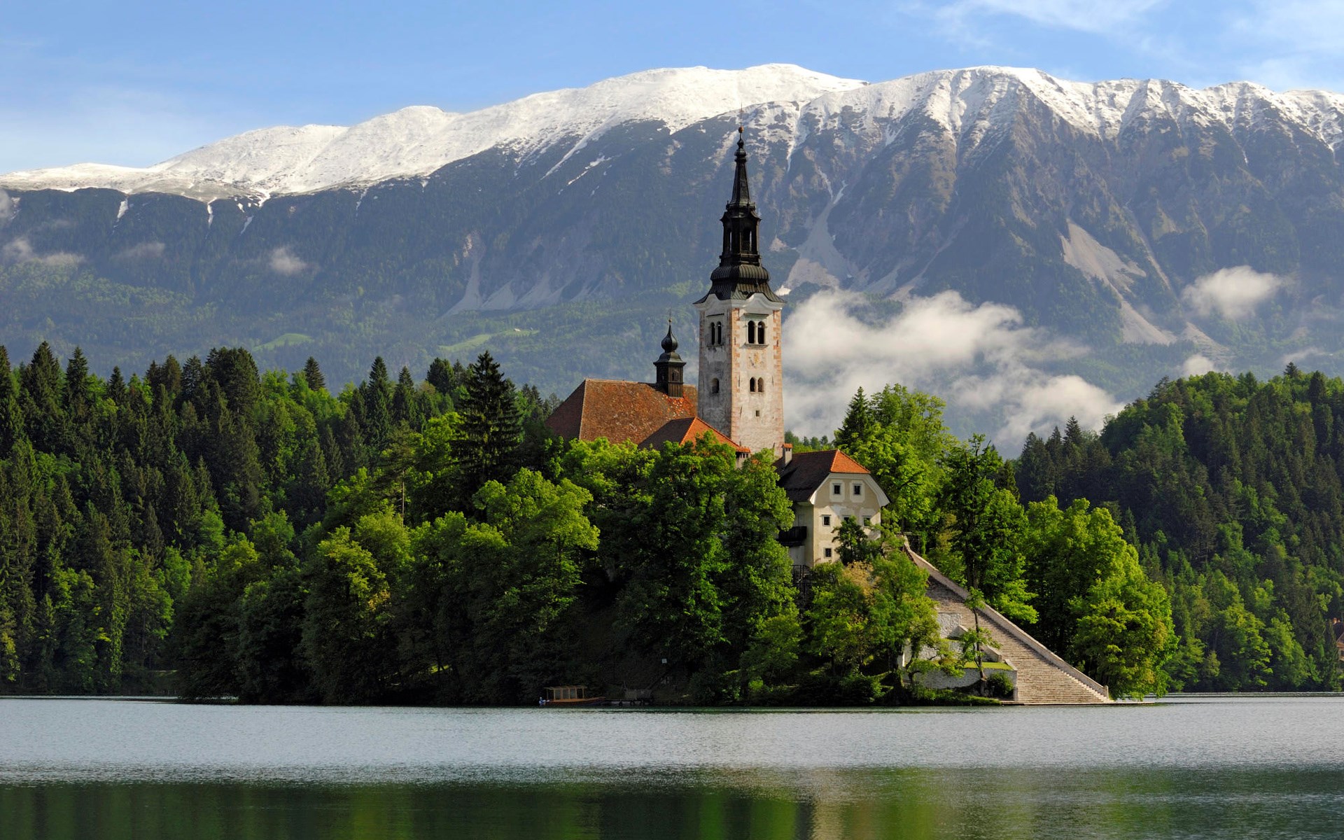 Church on an island in a lake with snowy mountains HD Wallpaper