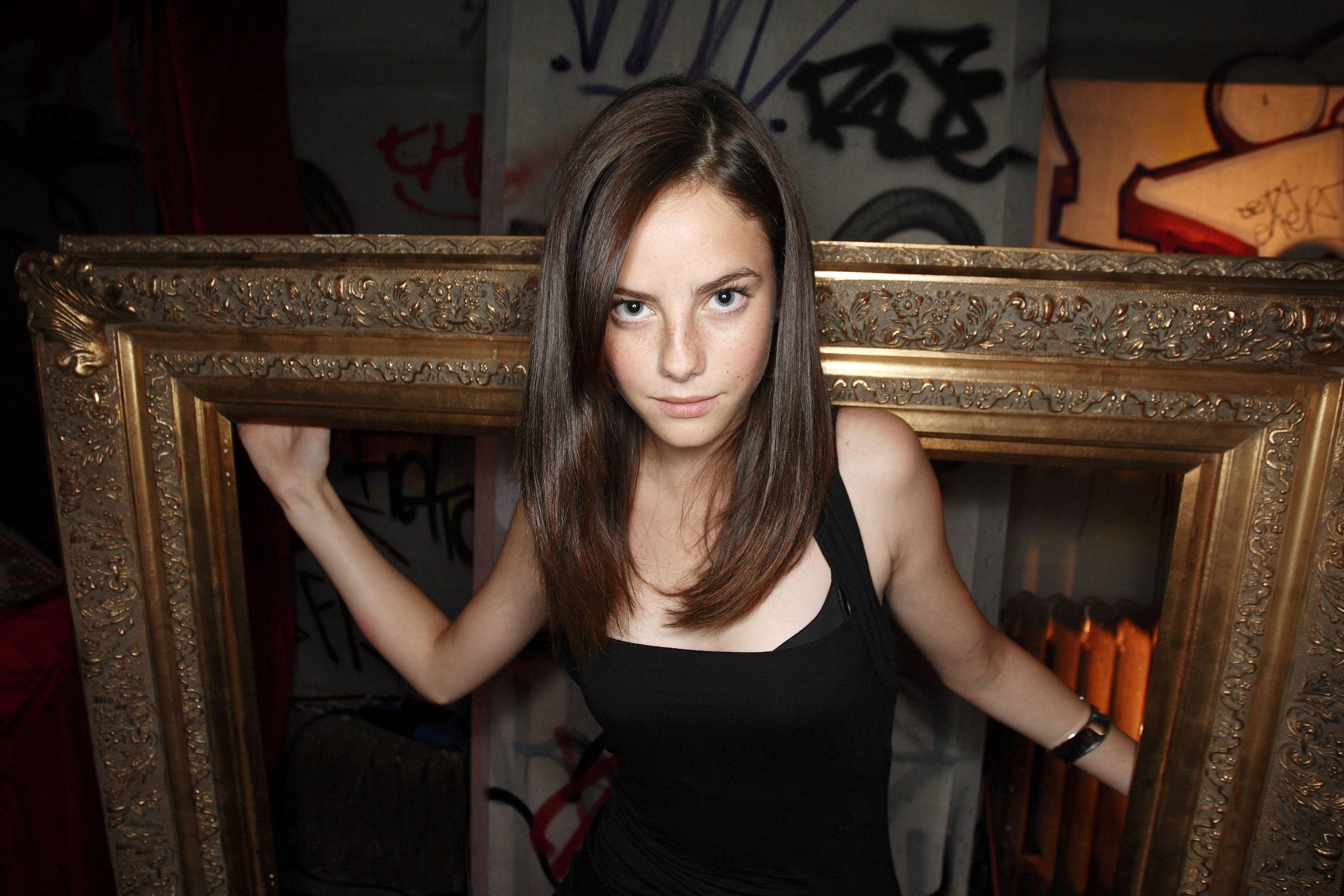 Kaya Scodelario posing in a golden frame HD Wallpaper
