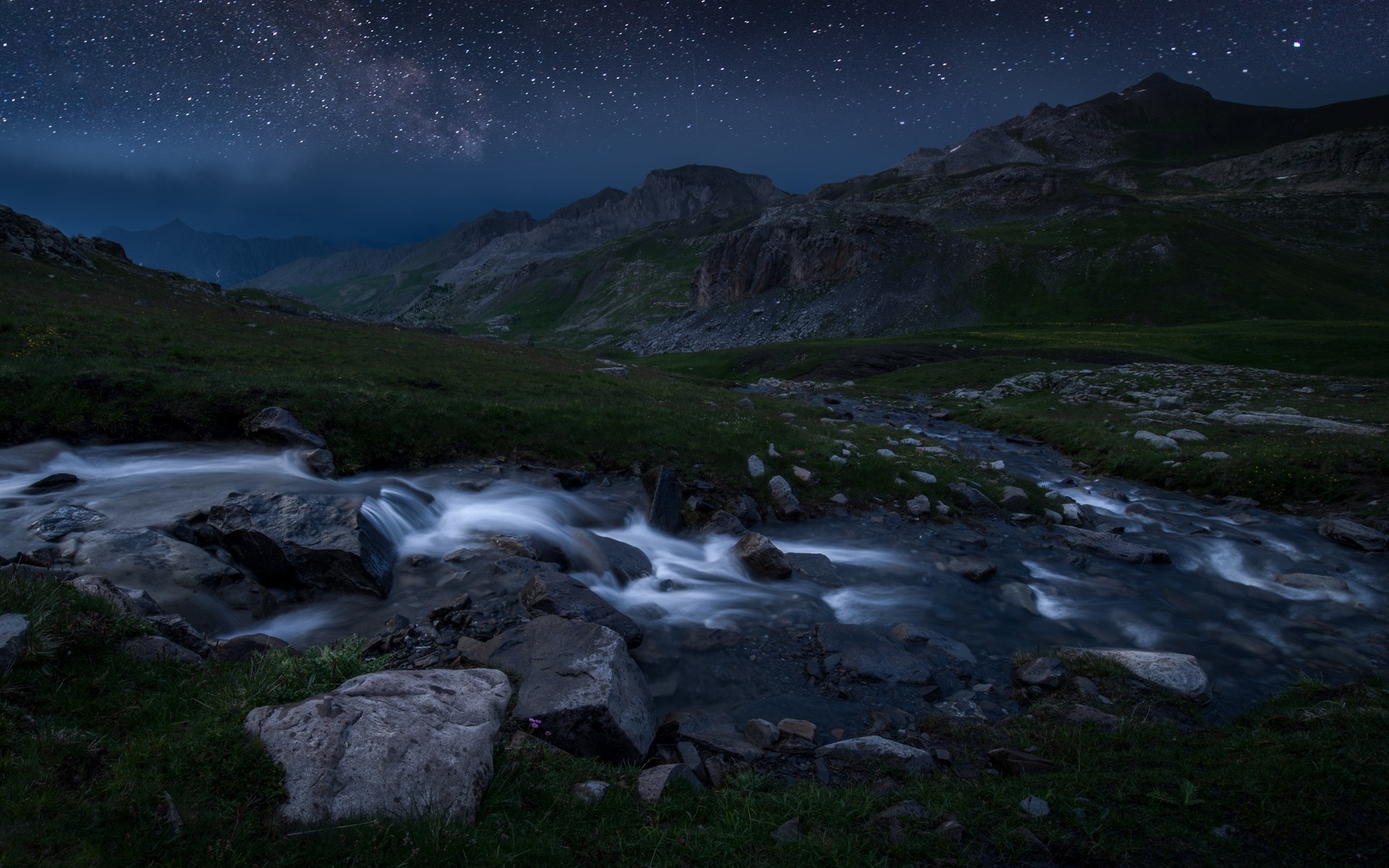 Starry night over a mountain stream in a valley HD Wallpaper