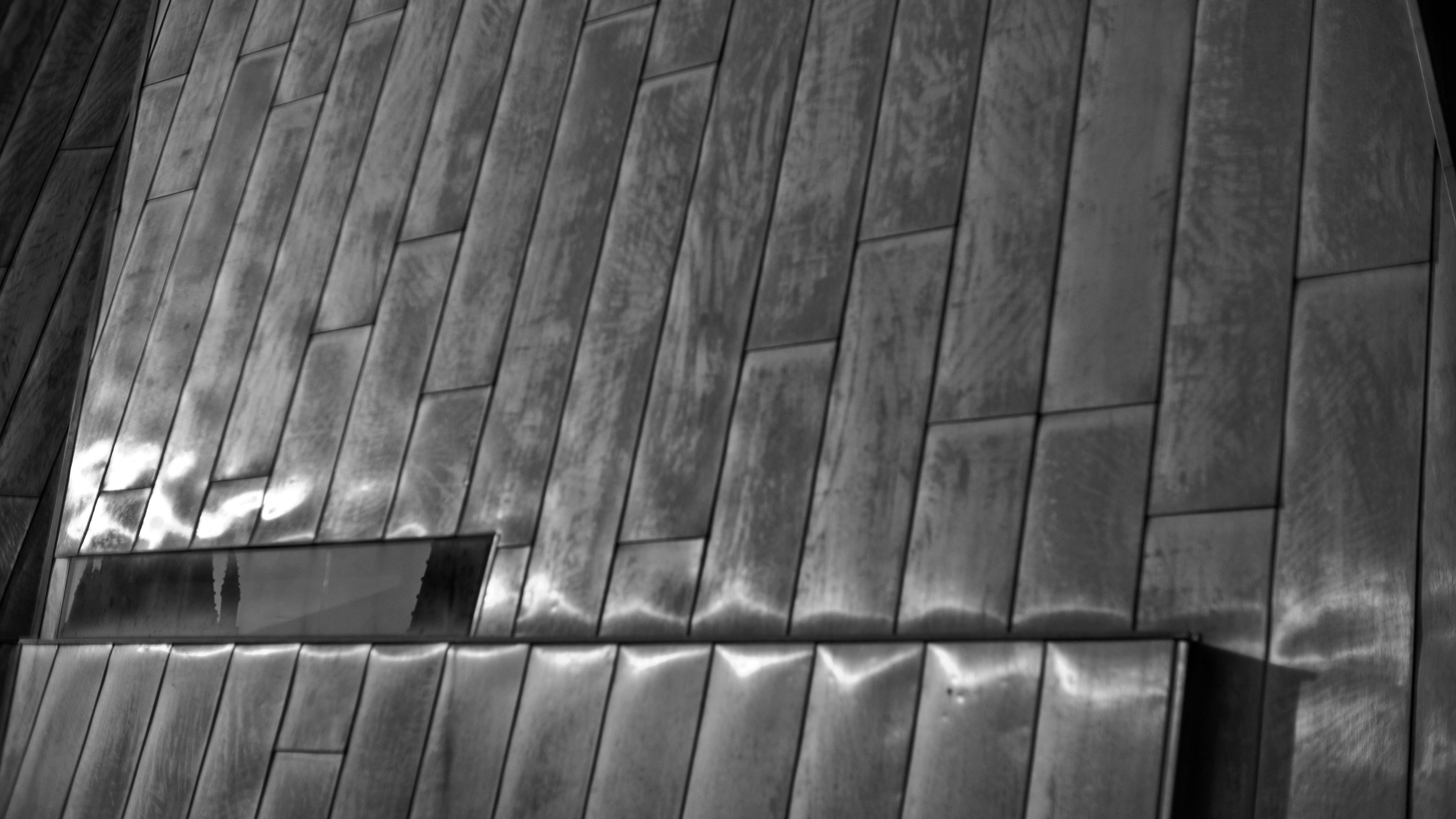 Monochrome facade with metallic tiles and a window HD Wallpaper