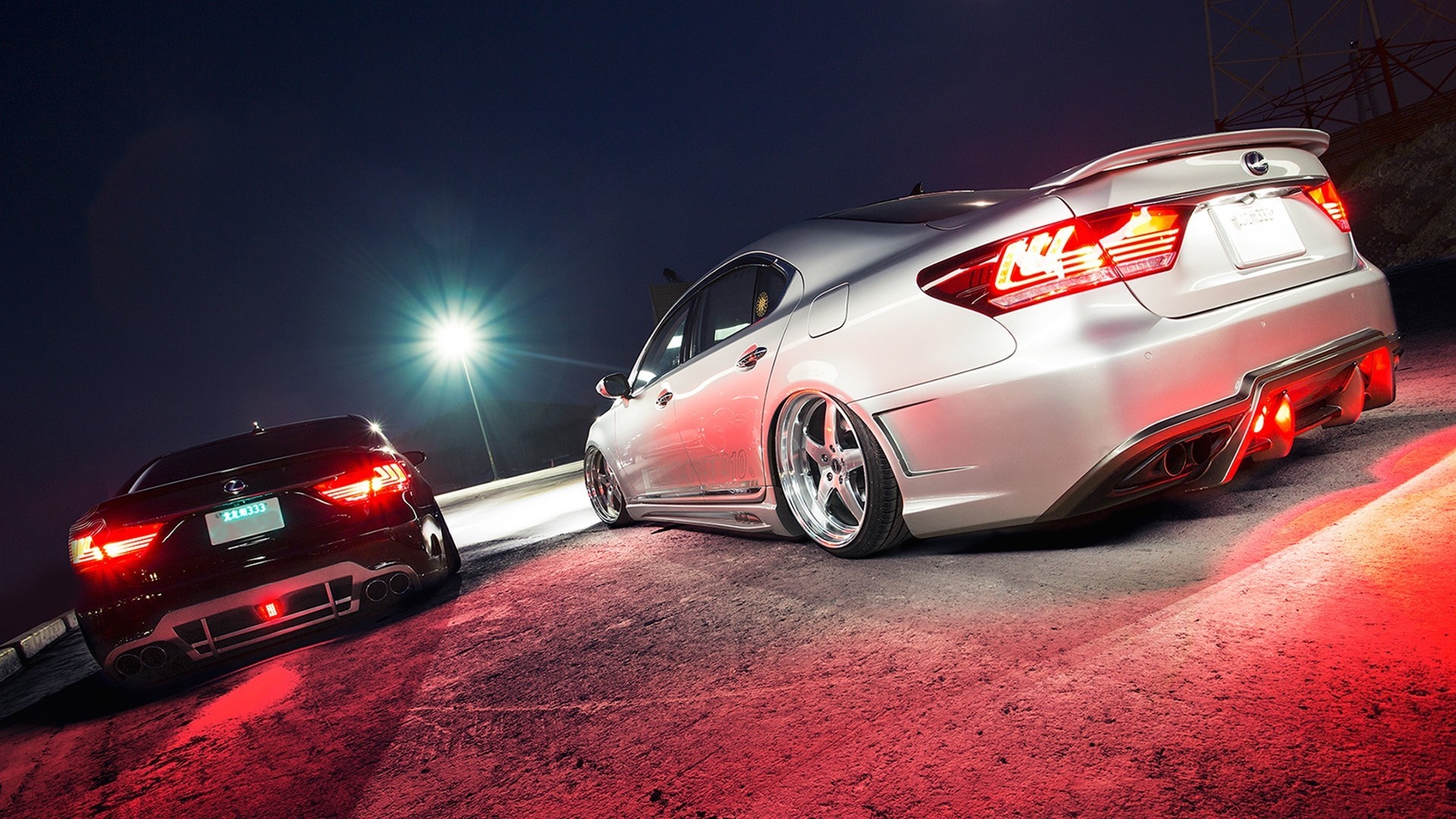 Two modified Lexus sedans at night with red lighting HD Wallpaper