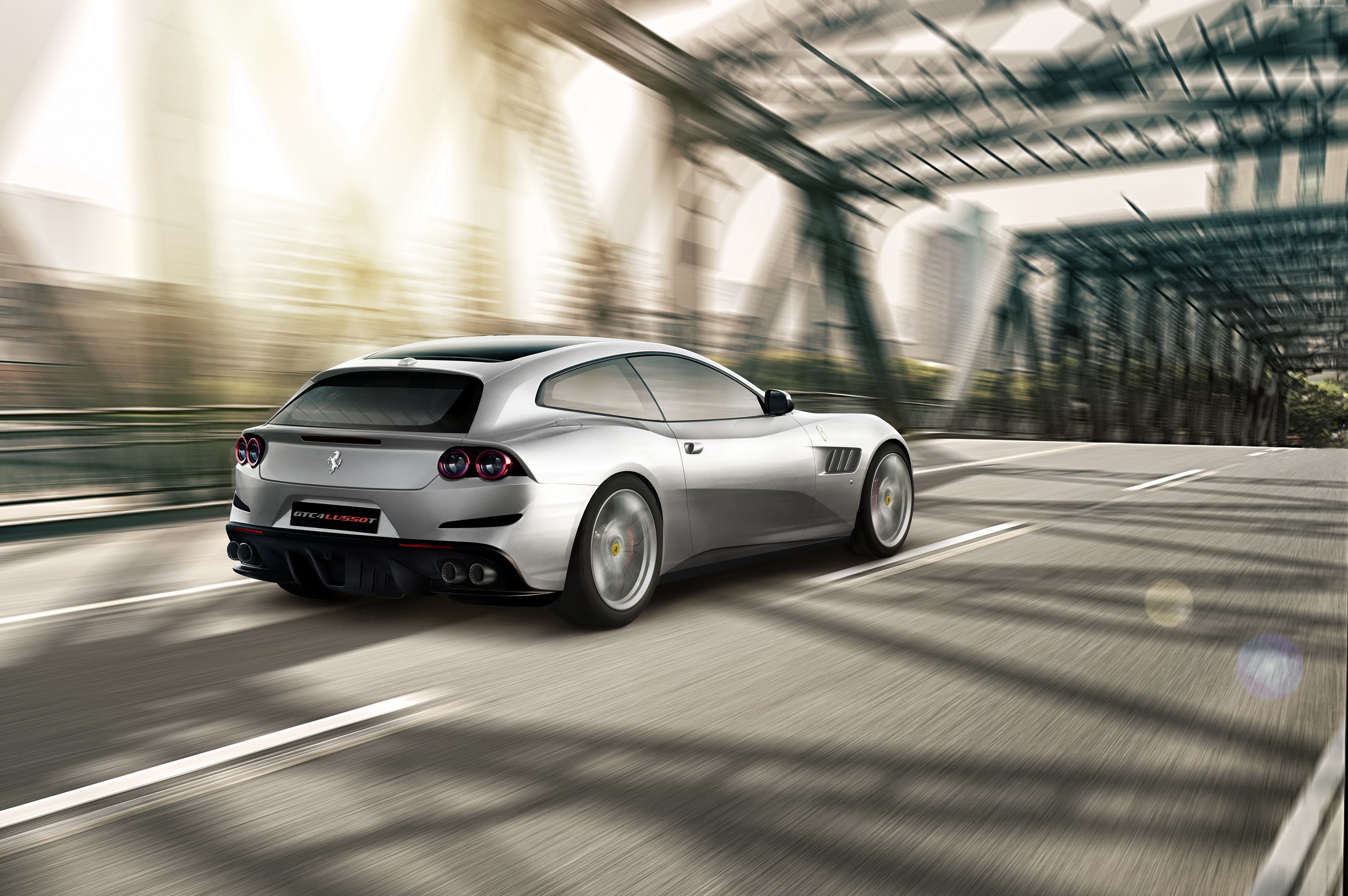 Silver Ferrari GTC4Lusso T driving on a bridge HD Wallpaper