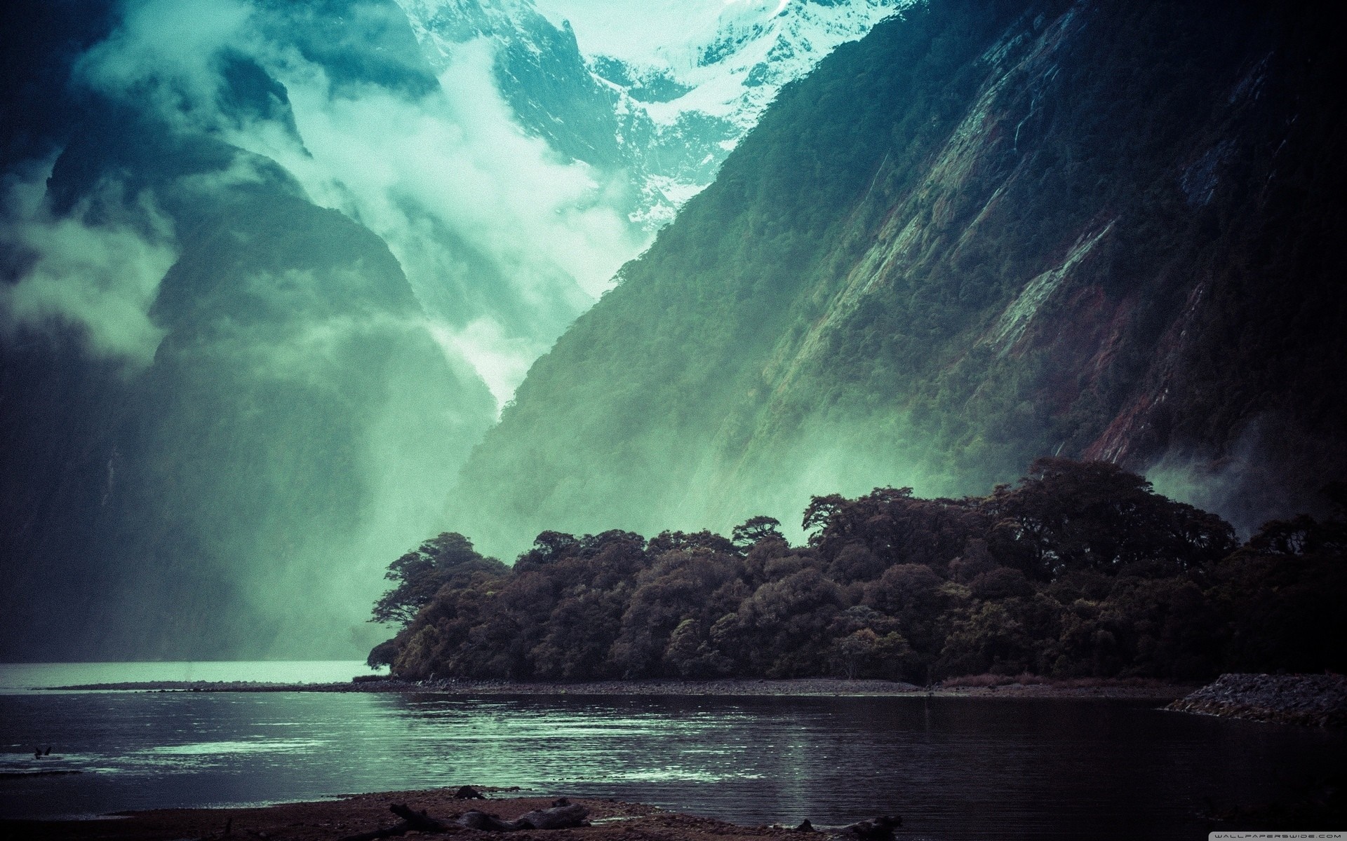 Misty Mountains Overlooking a Forested Shoreline HD Wallpaper