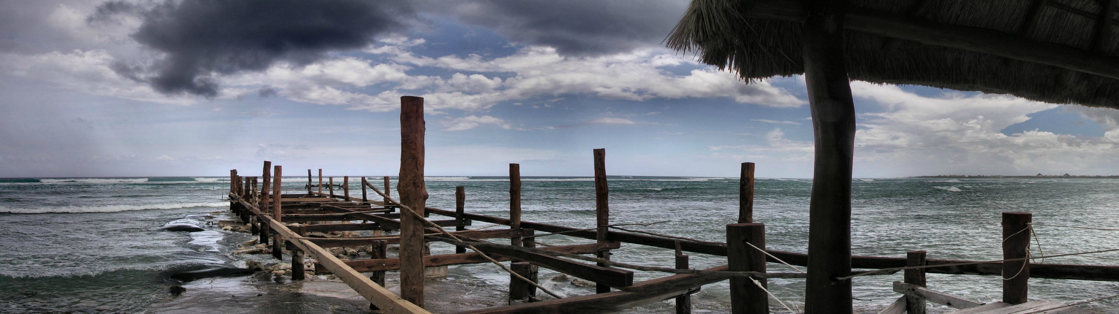Wooden pier on a stormy ocean with dark clouds HD Wallpaper