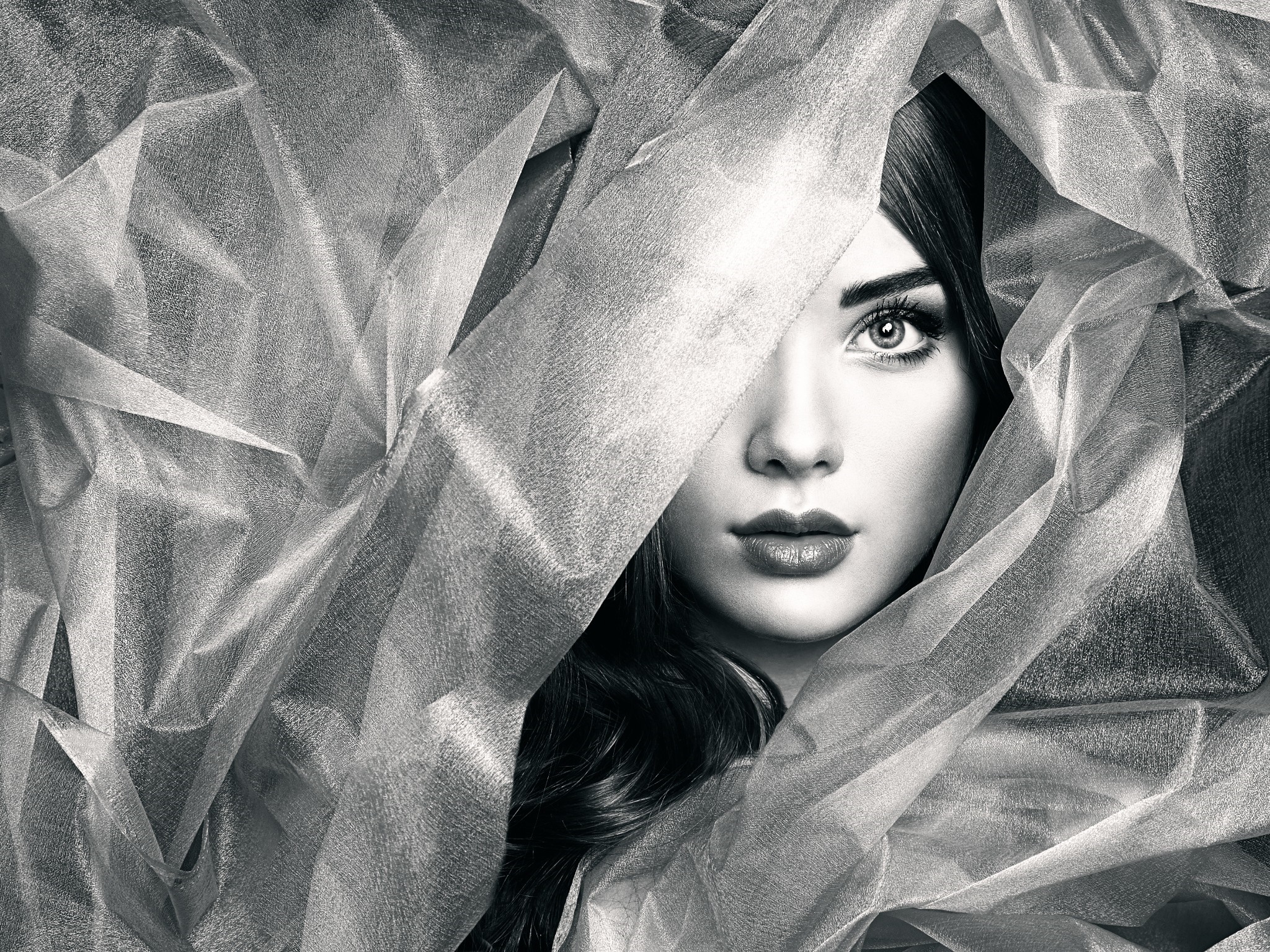 Monochrome portrait of a woman partially covered by fabric HD Wallpaper
