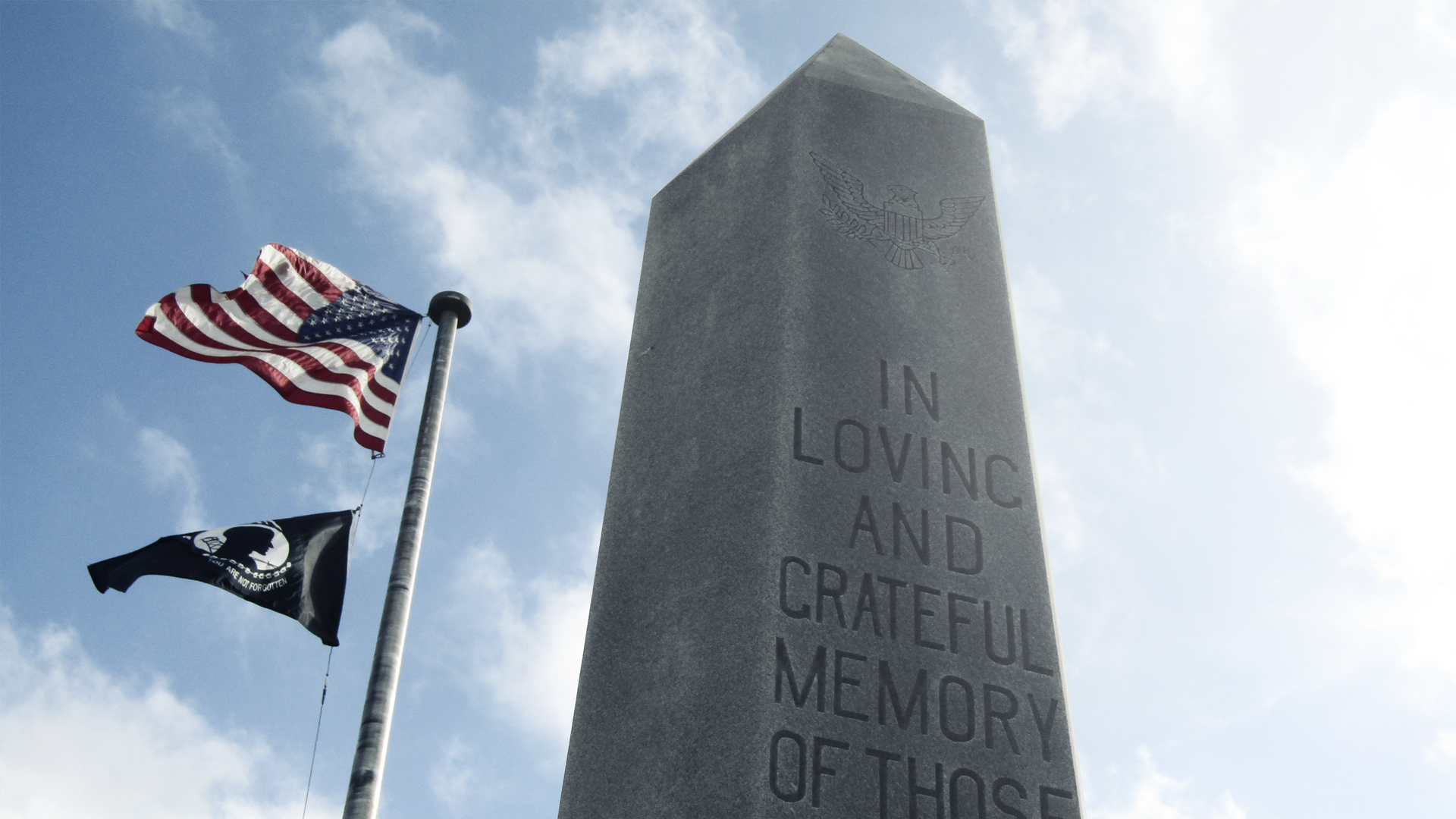 American flag and POW/MIA flag at a memorial monument HD Wallpaper