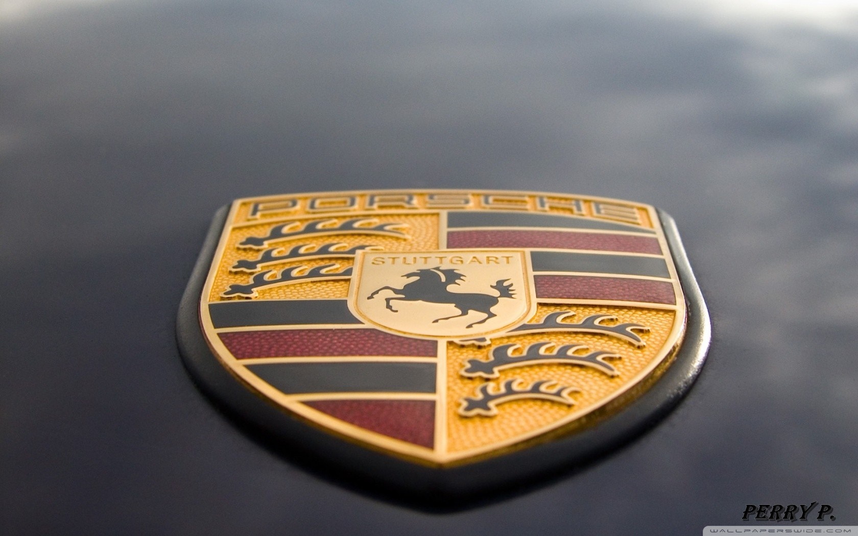 Porsche emblem on a dark surface HD Wallpaper