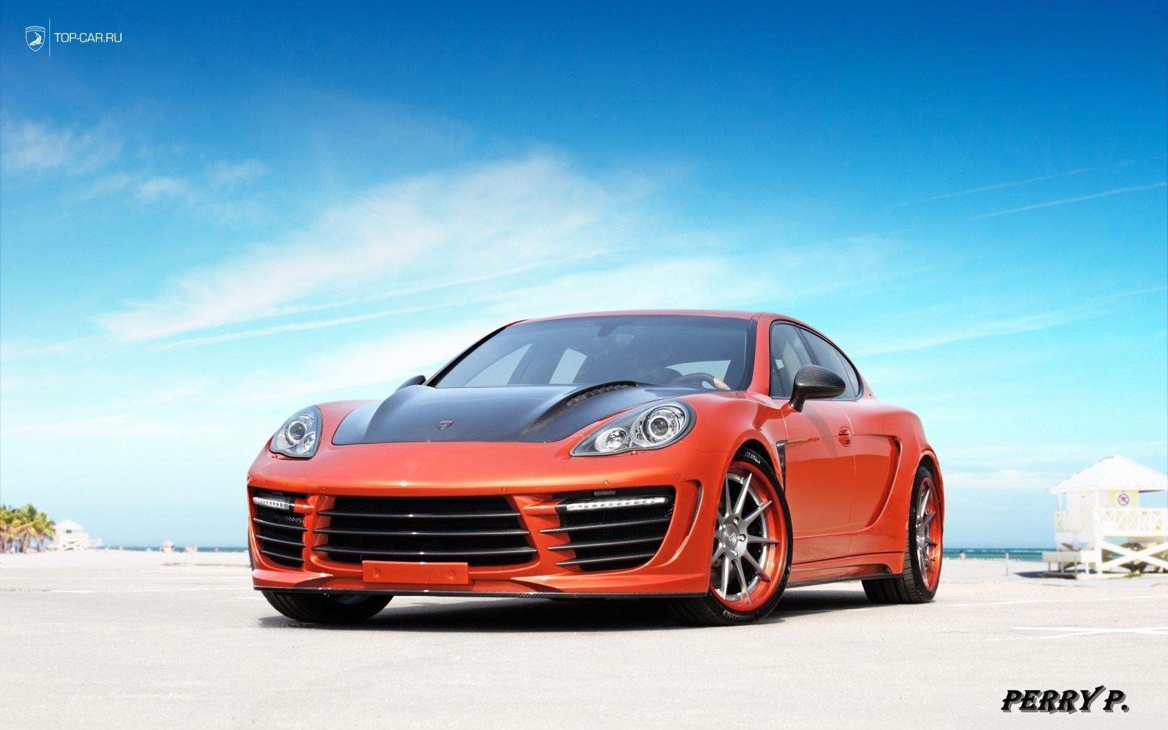 Orange Porsche Panamera with black hood on a beach HD Wallpaper