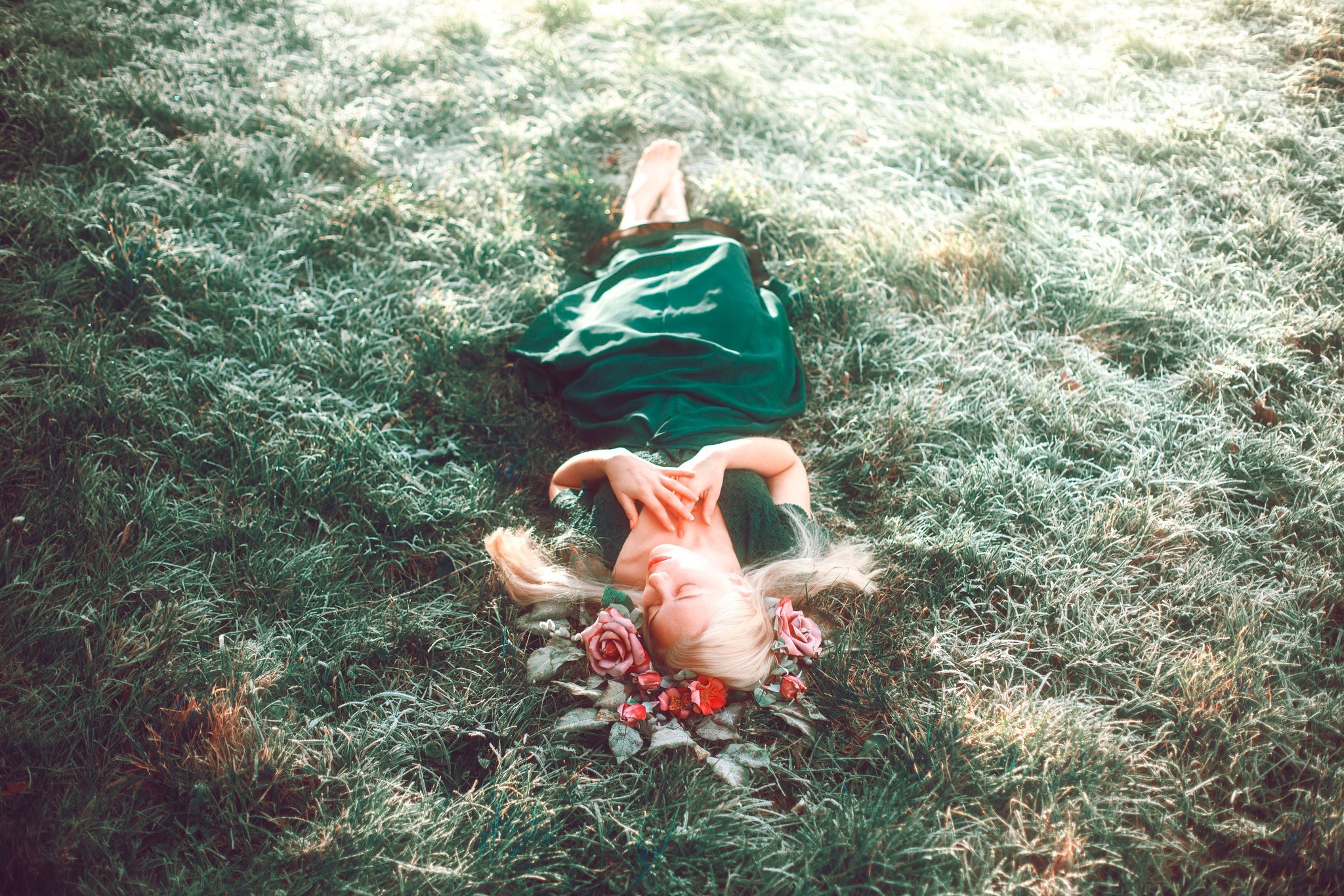 Woman in green dress lying on grass with flowers HD Wallpaper