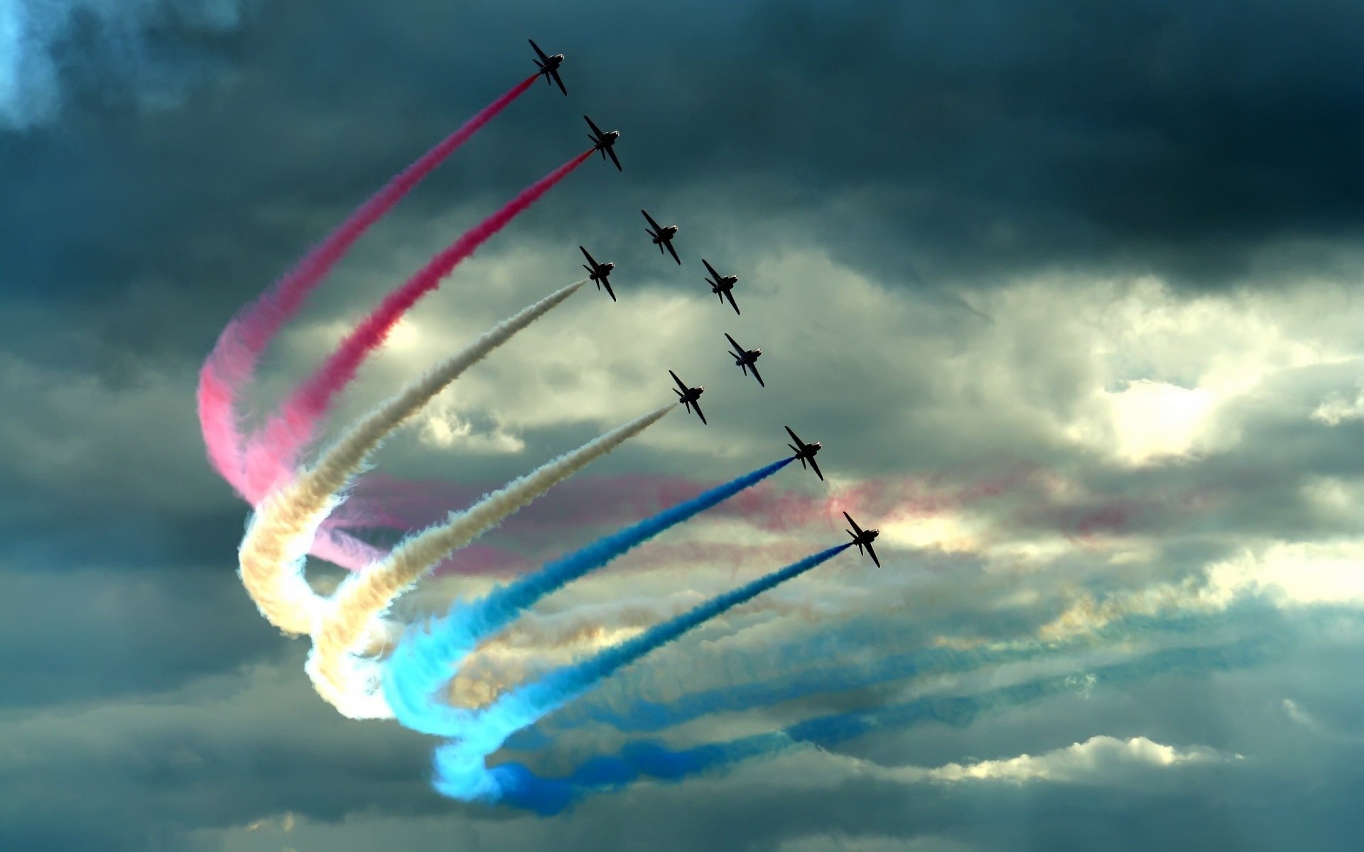 Airplanes performing aerobatics with colored smoke trails HD Wallpaper