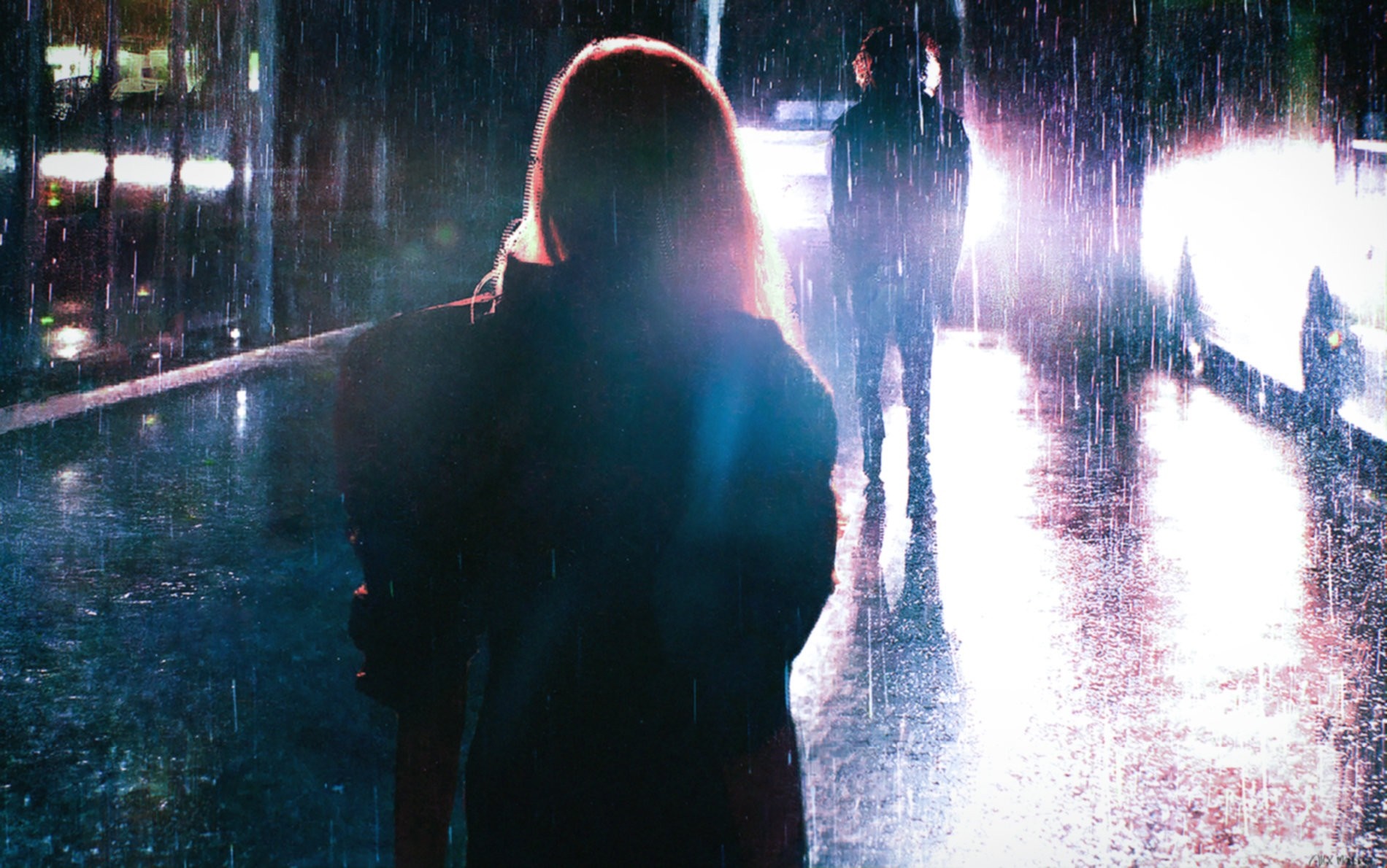 Two figures in the rain at night with car headlights HD Wallpaper