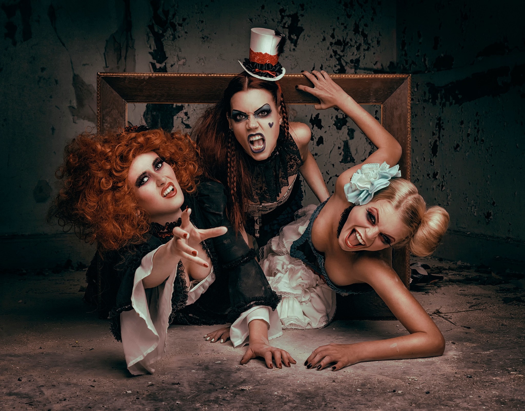 Three women in theatrical costumes in a derelict room HD Wallpaper